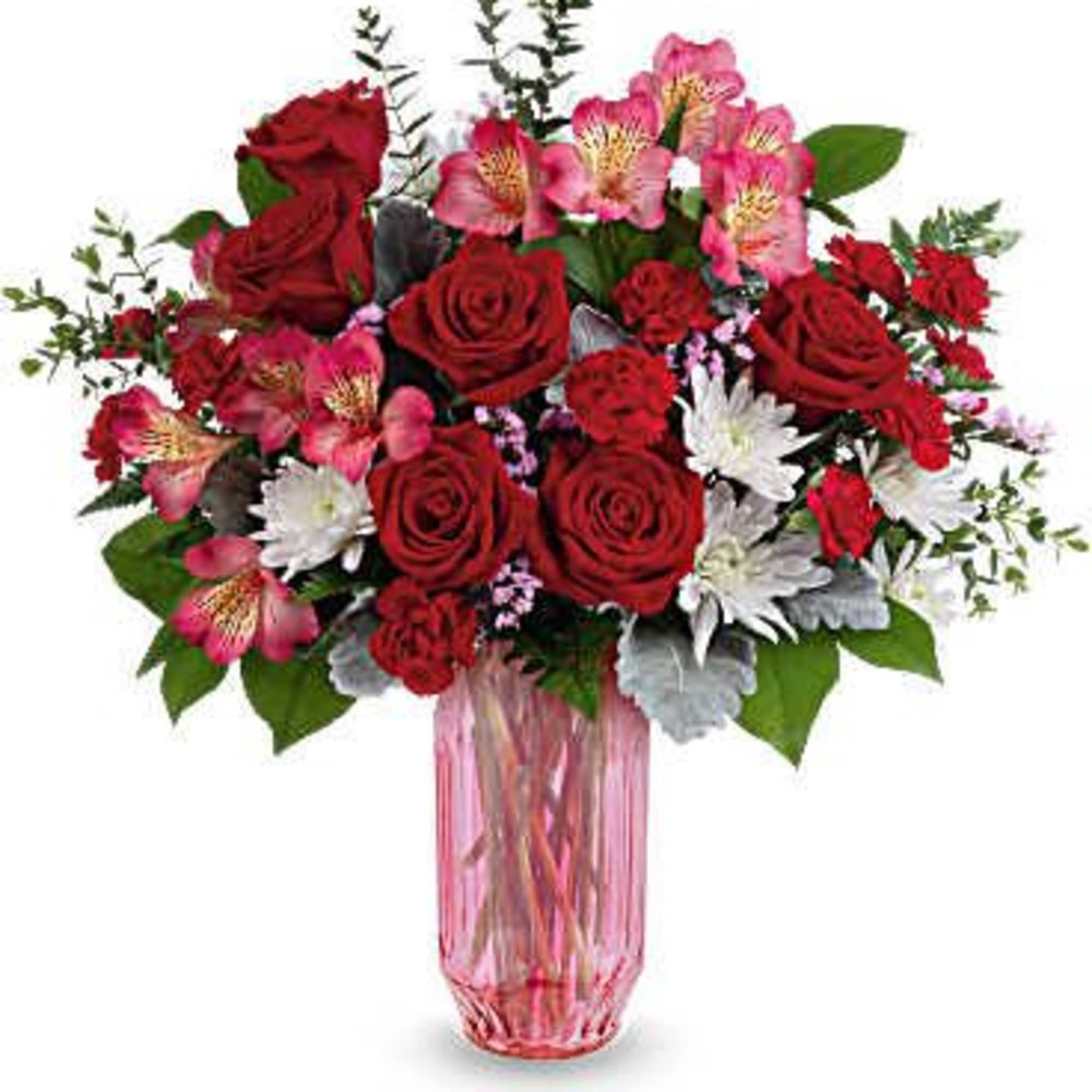 Red roses and pink flowers in a pink glass vase