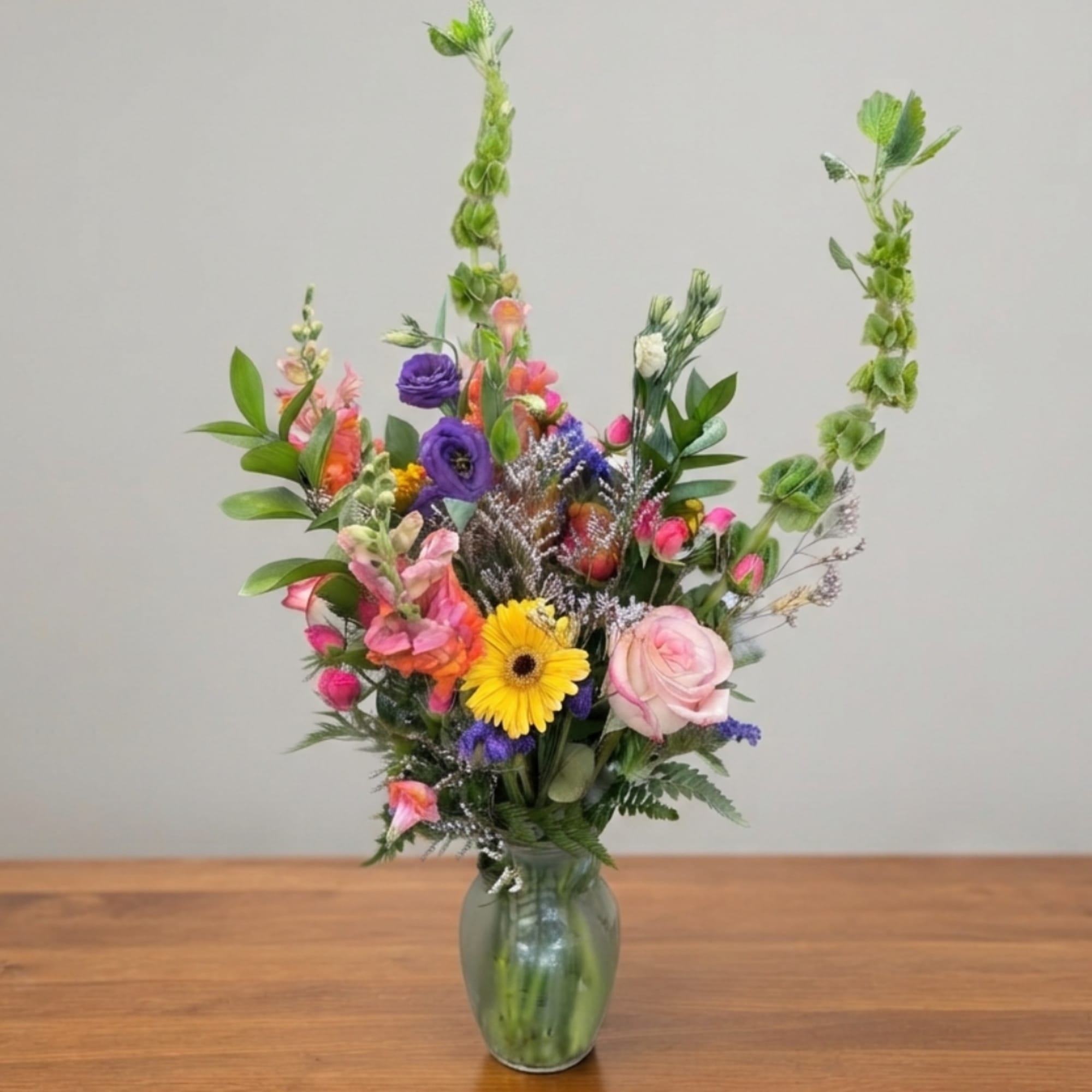 Colorful mixed flower arrangement in a glass vase