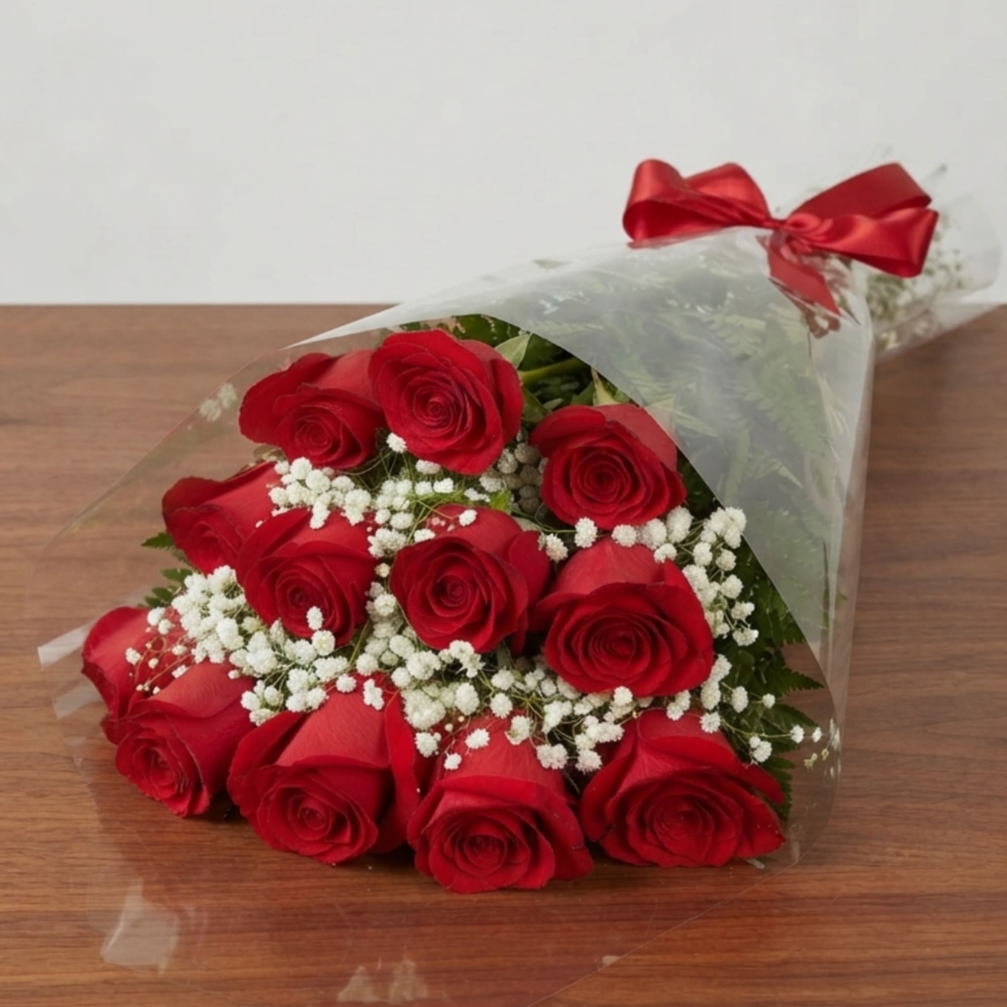 Bouquet of red roses with white baby's breath in clear wrap