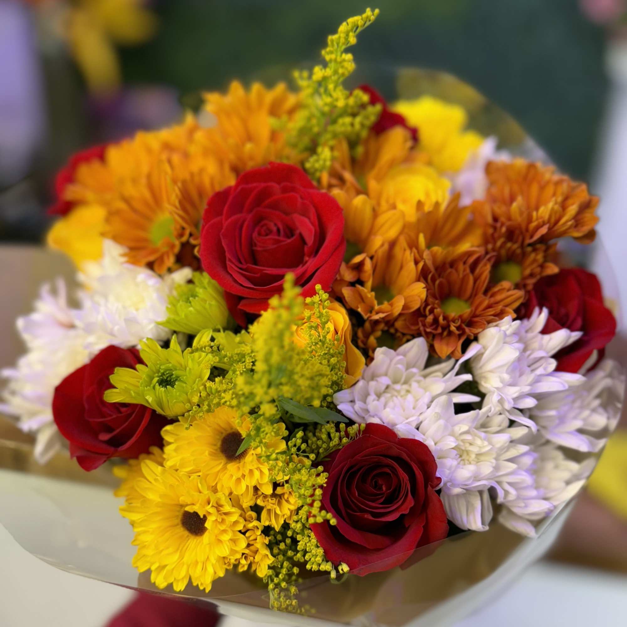 "A stunning blend of red, yellow roses and daisies in autumn hues, photo 2 of 2