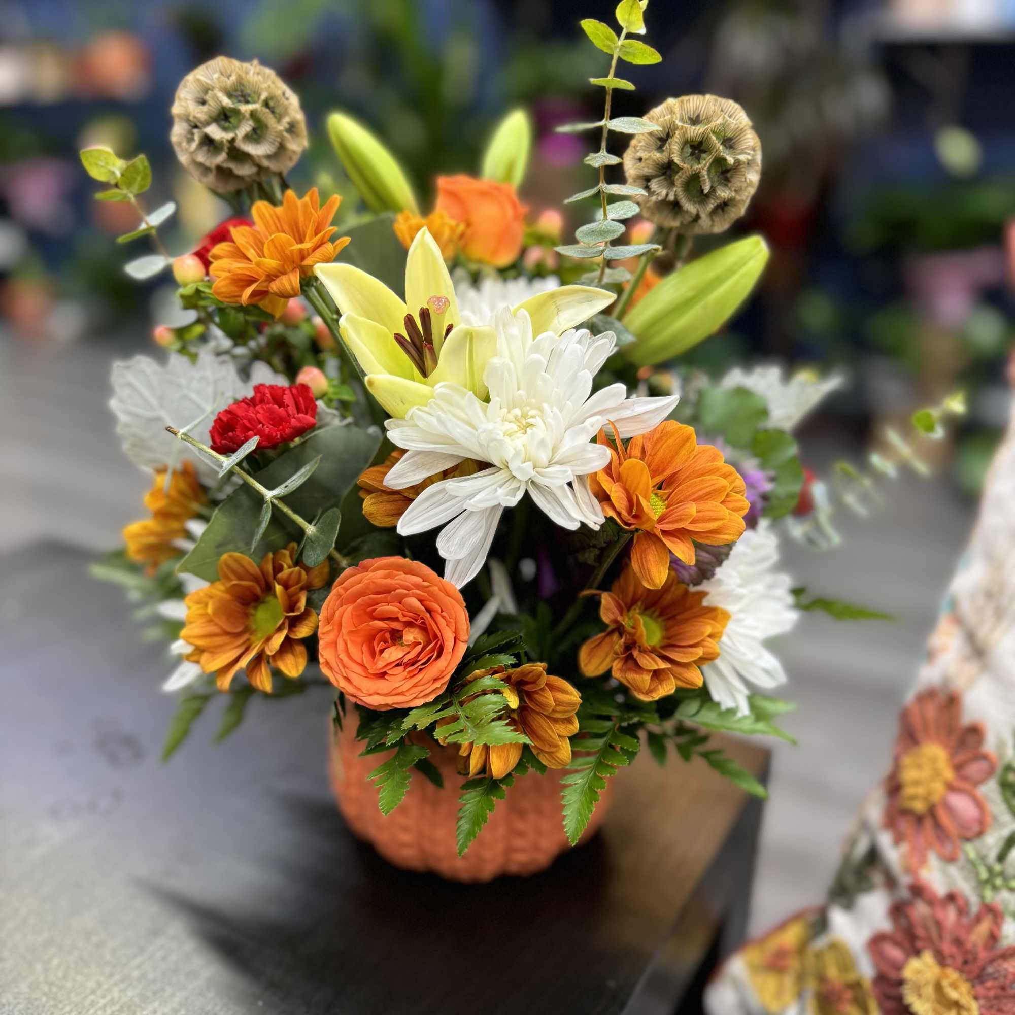 &ldquo;A unique arrangement set in a natural pumpkin, featuring vibrant, handpicked flowers