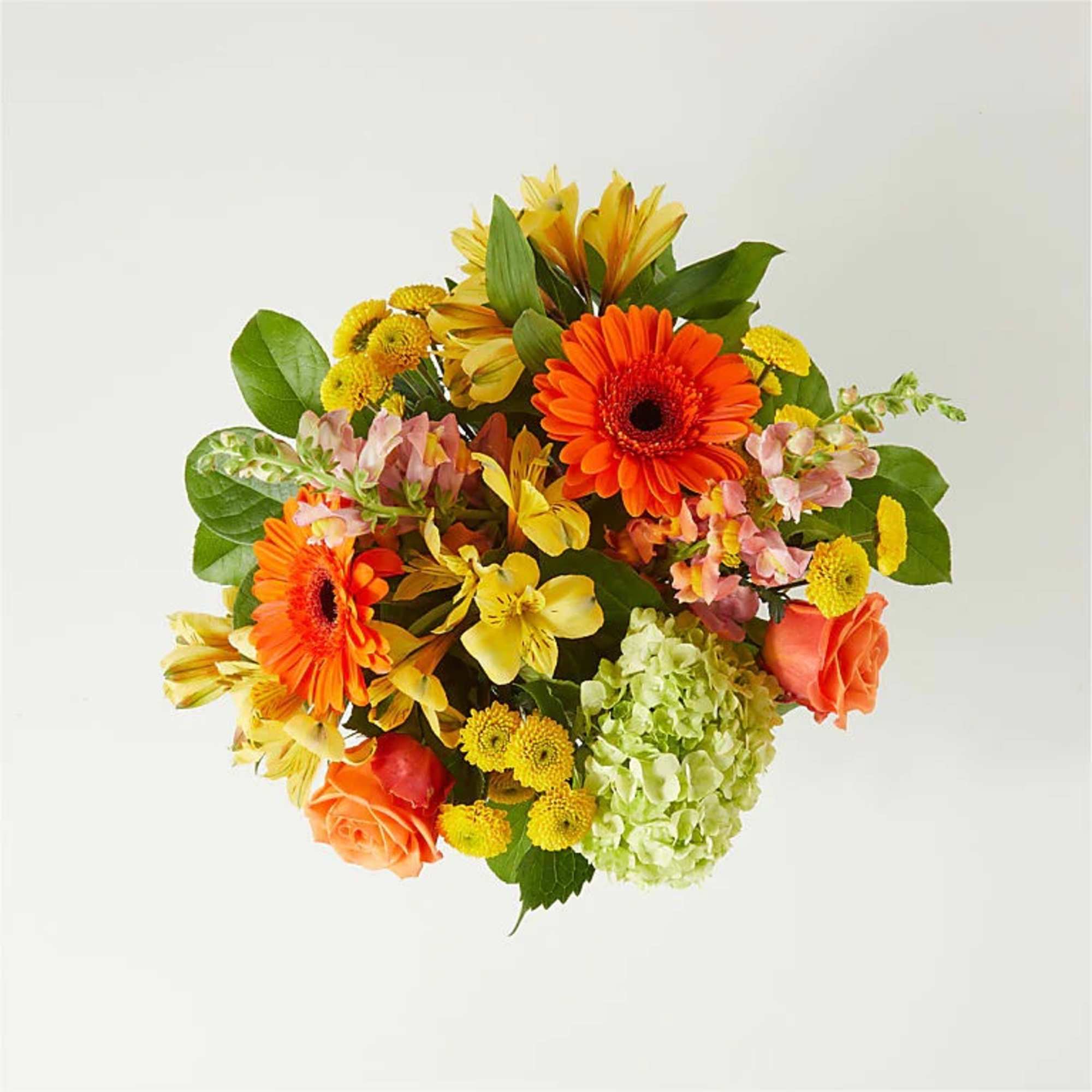 Bright mixed bouquet with orange gerberas, yellow blooms, and green hydrangea