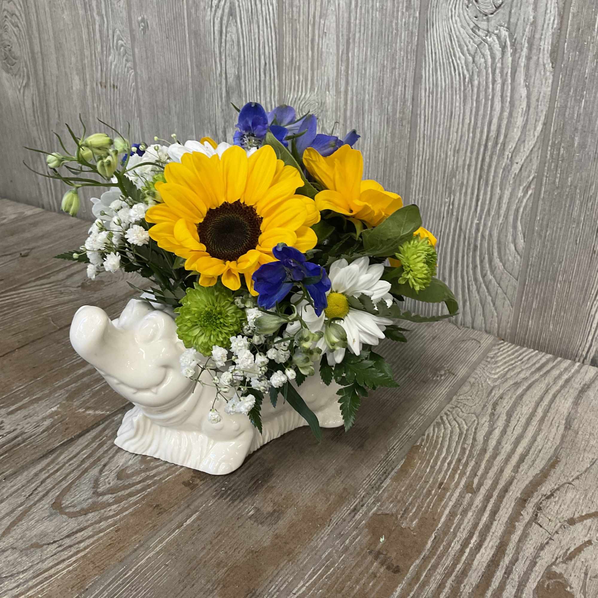Mixed bouquet in a white ceramic rabbit container
