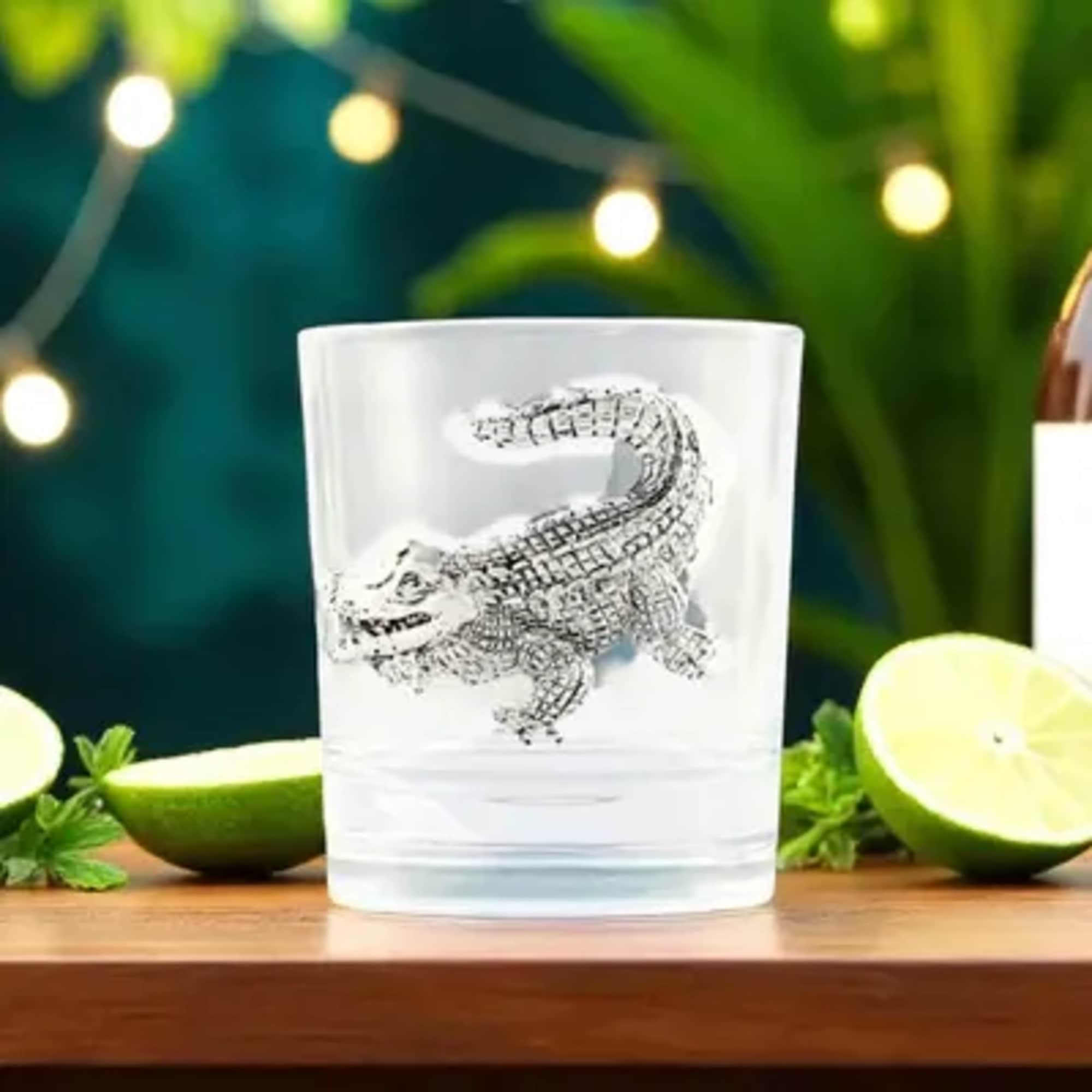 Clear glass tumbler with a crocodile design on the front