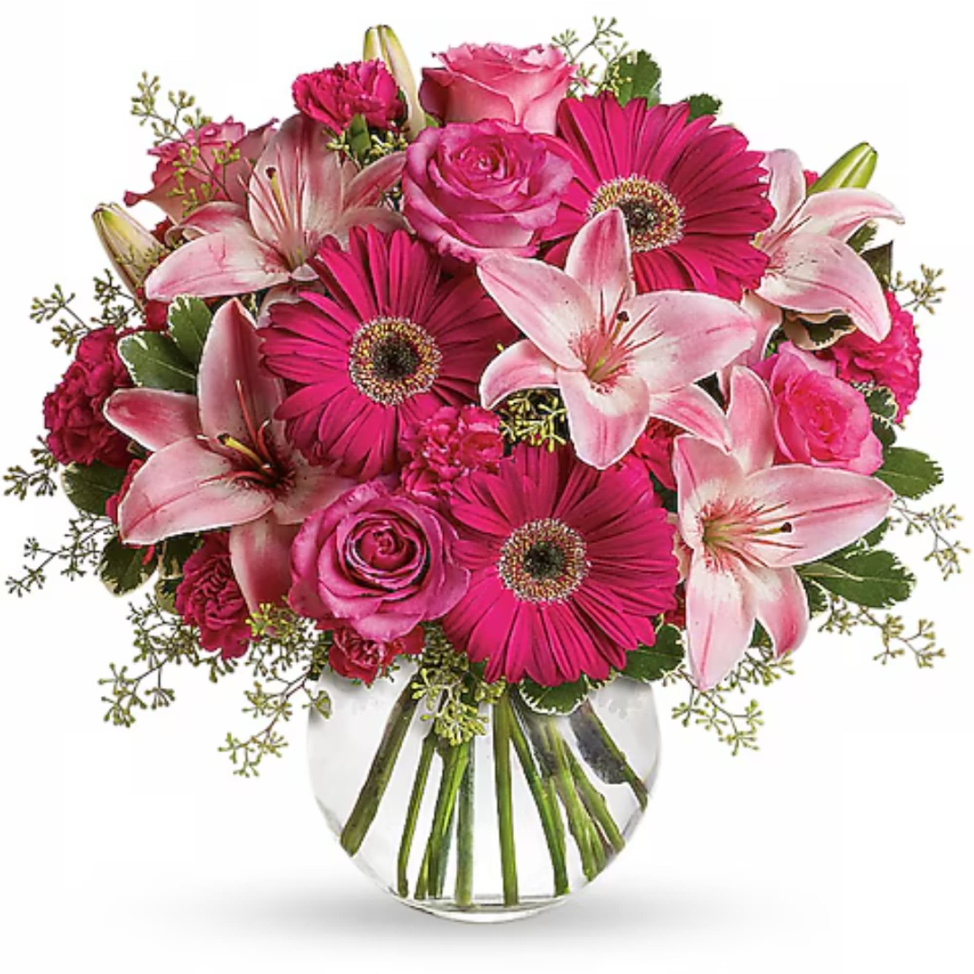 Pink lilies, roses, and gerbera daisies in a clear glass vase