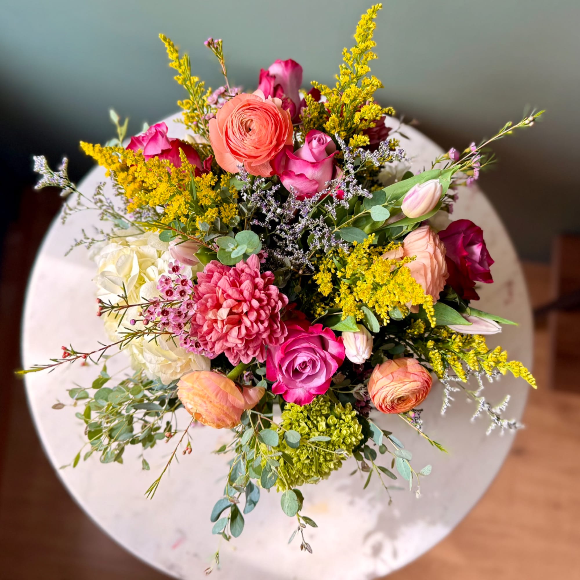 Mixed bouquet of pink, peach, white, and yellow flowers