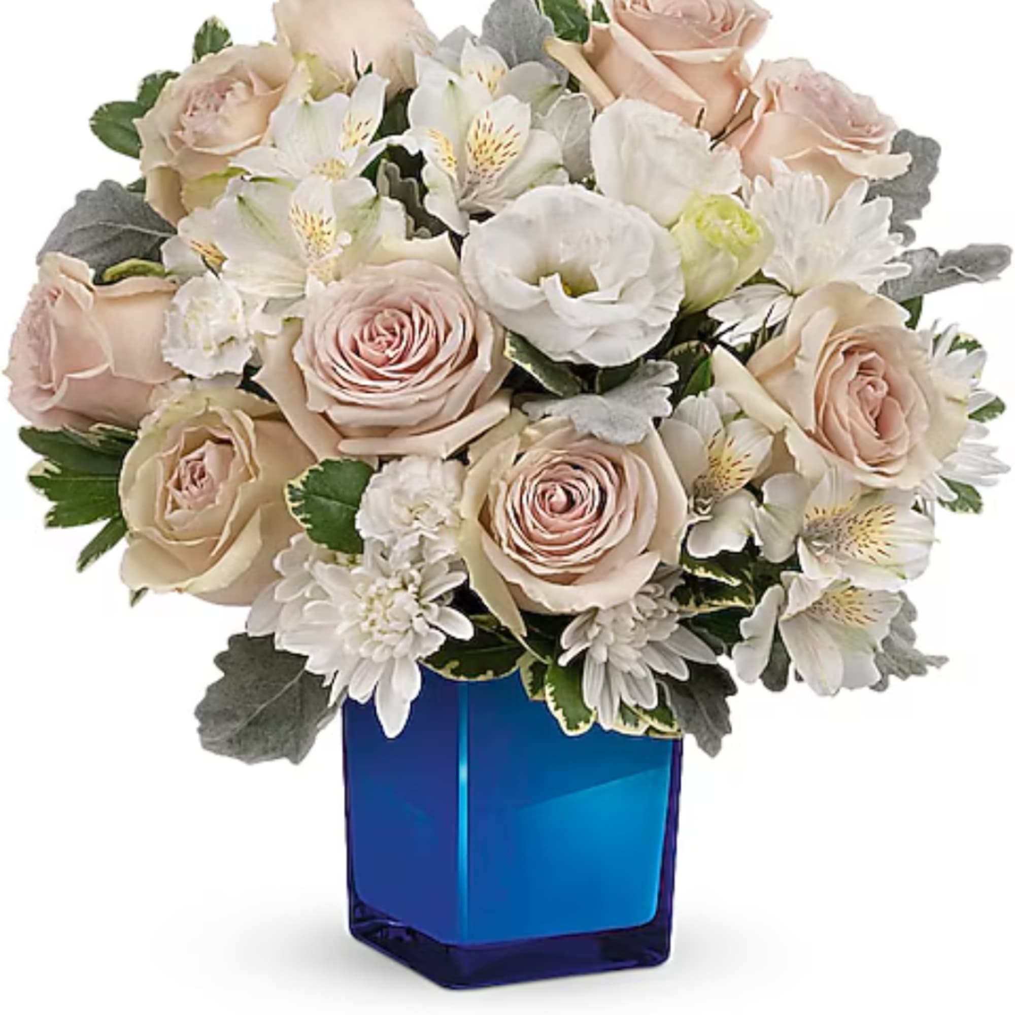Blush roses and white flowers in a blue glass vase