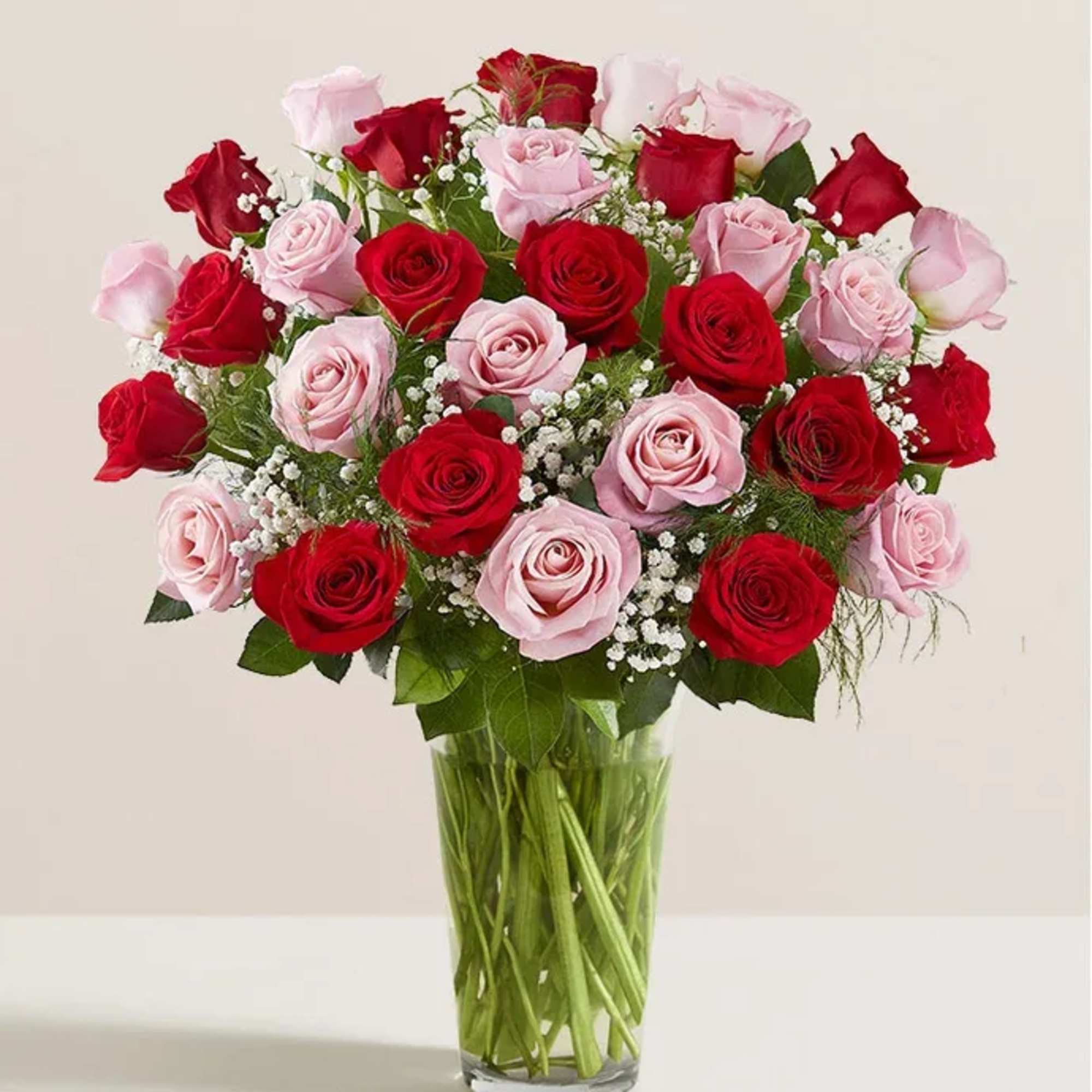 Bouquet of red and pink roses in a clear glass vase