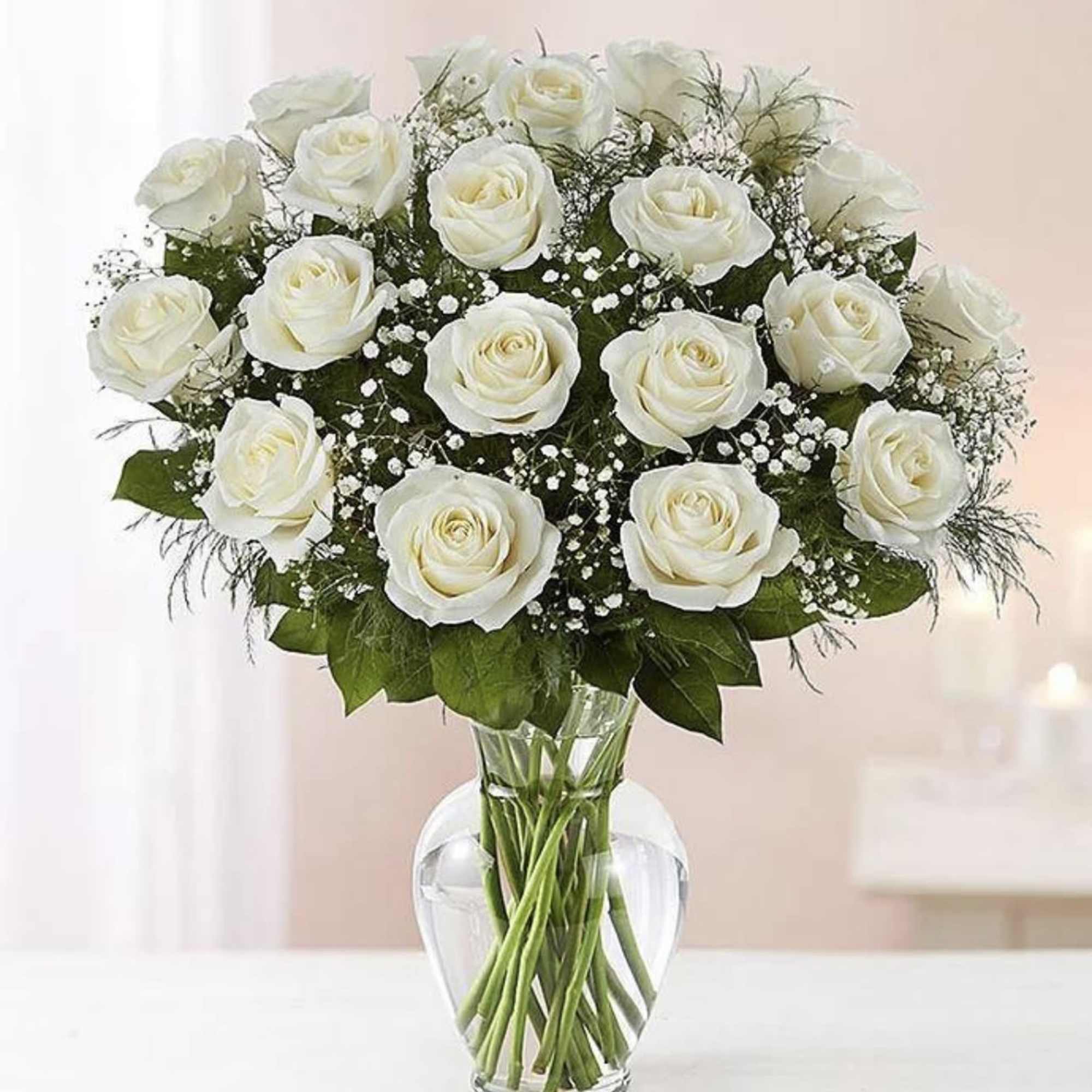 White roses arranged in a clear glass vase