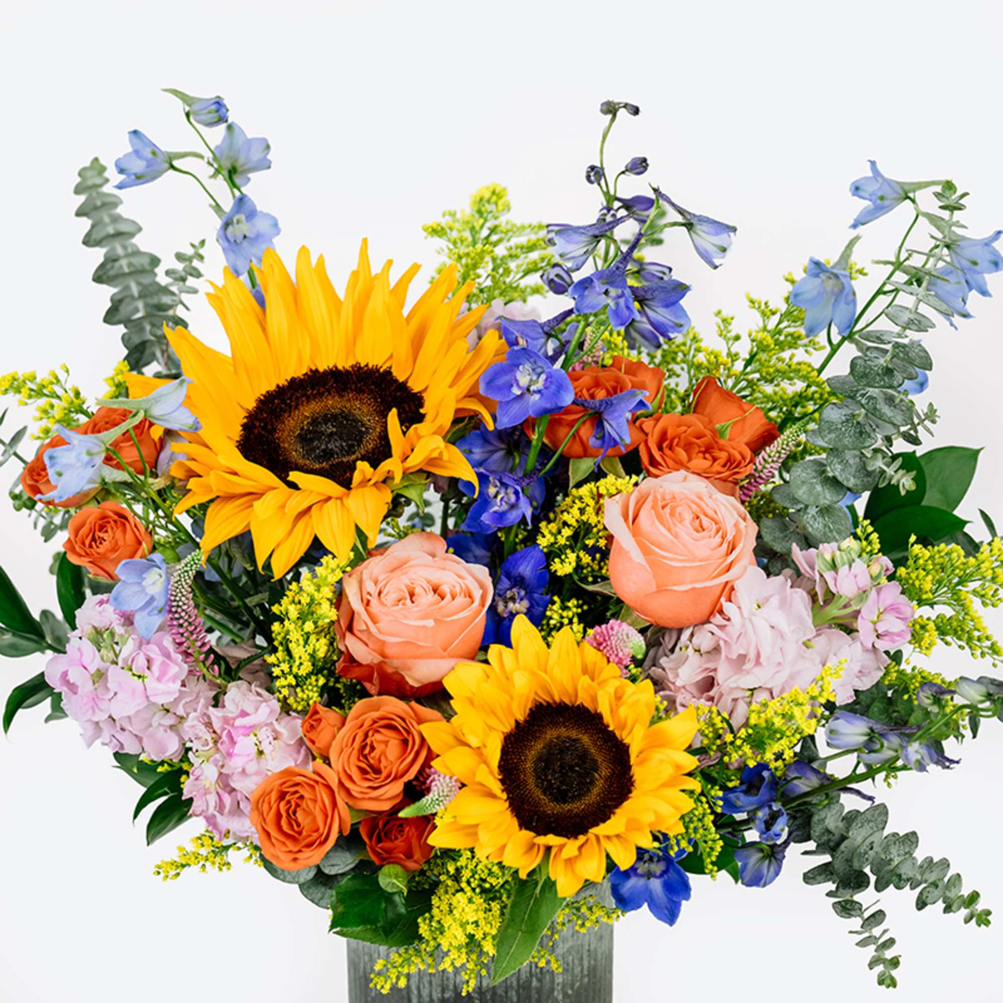 Bouquet with sunflowers, orange roses, and blue delphinium in a vase