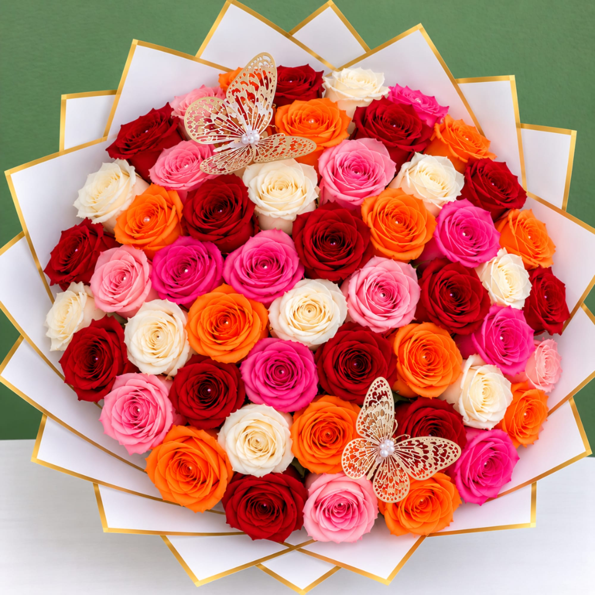 Round bouquet of multicolored roses with butterfly decorations