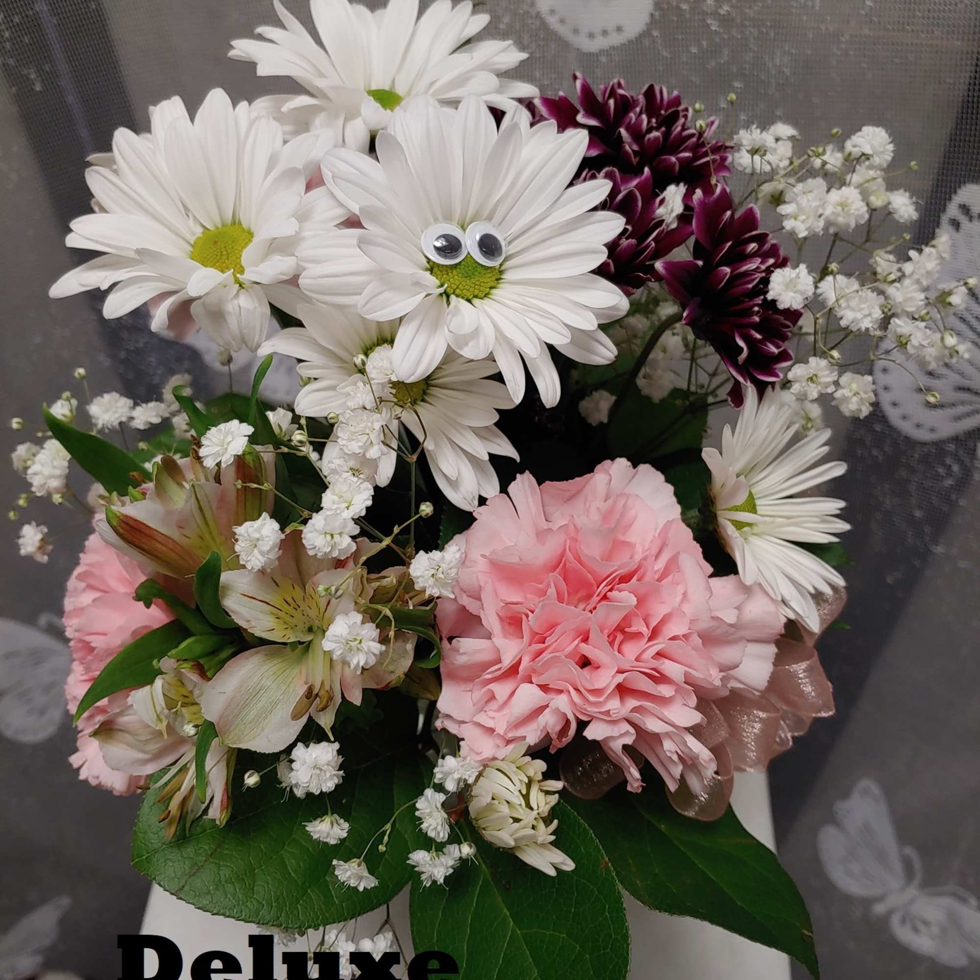 Bouquet of white daisies, pink carnations, and purple mums