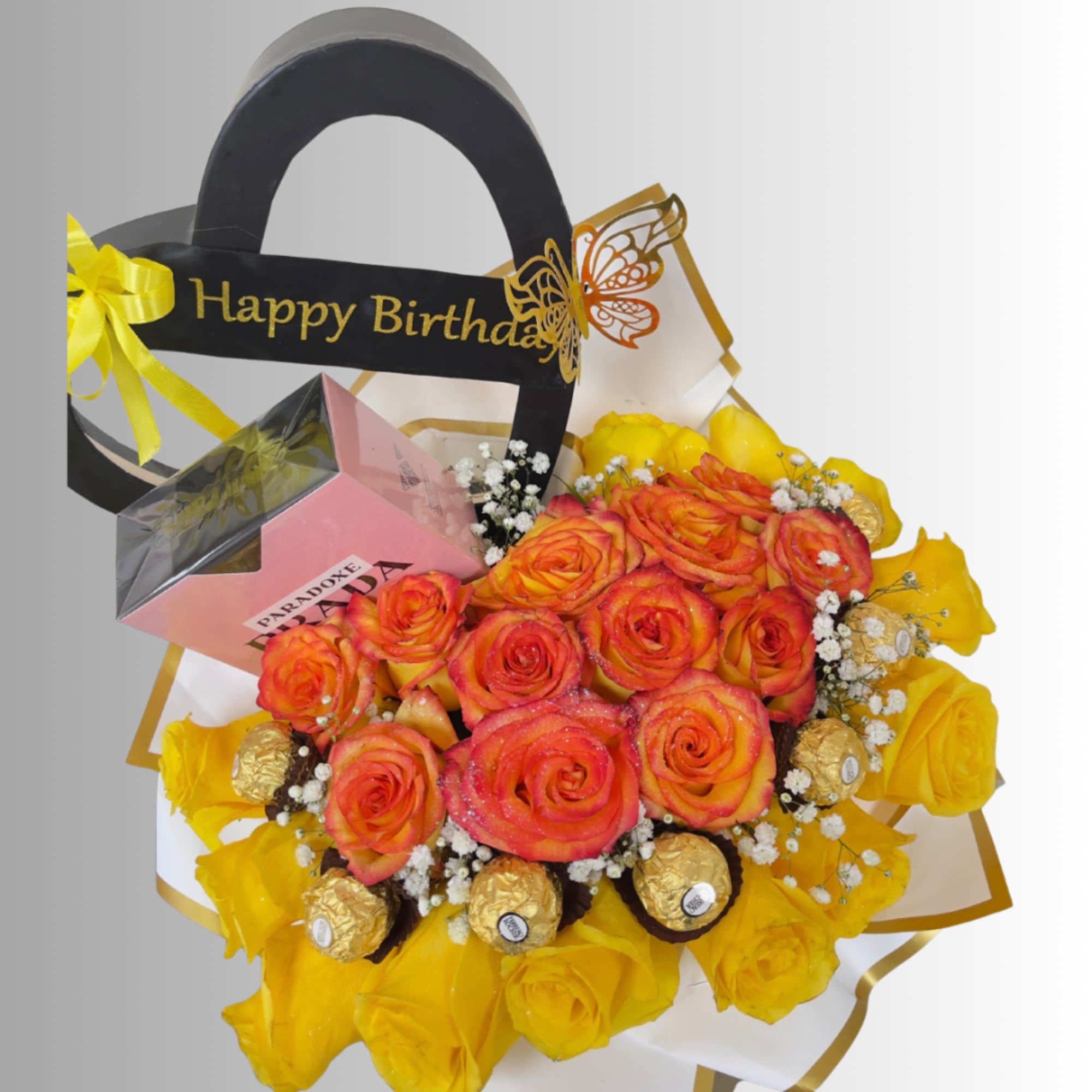 Bouquet of orange and yellow roses with chocolates and a Happy Birthday topper