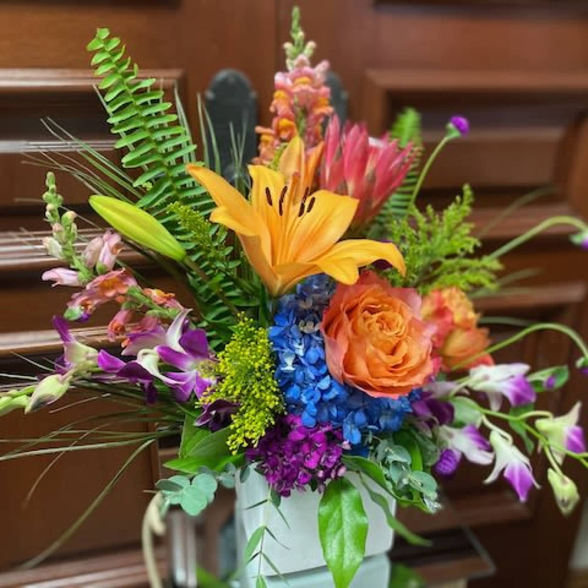 Colorful mixed flower arrangement in a white vase