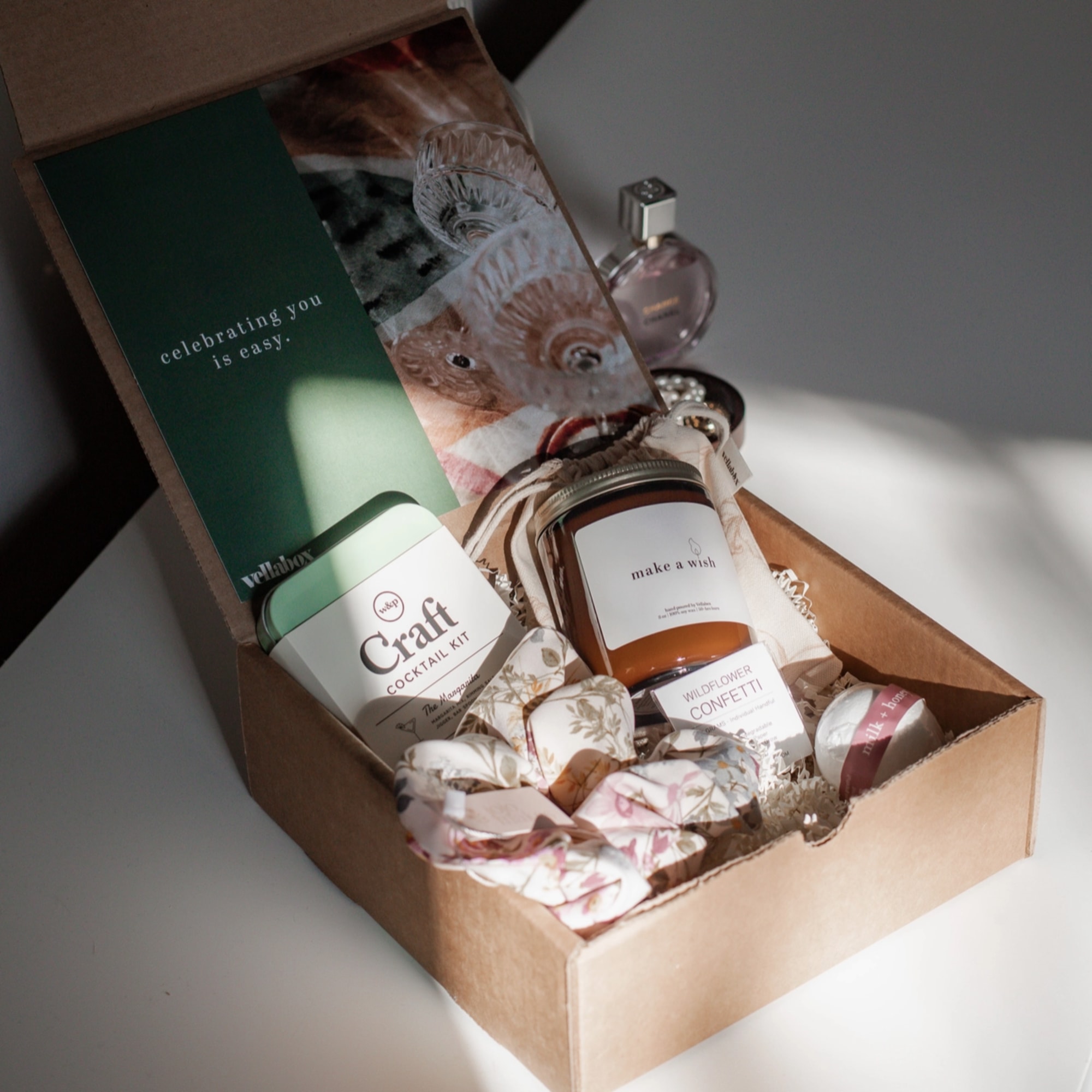 Gift box with cocktail kit, candle, perfume, and confetti