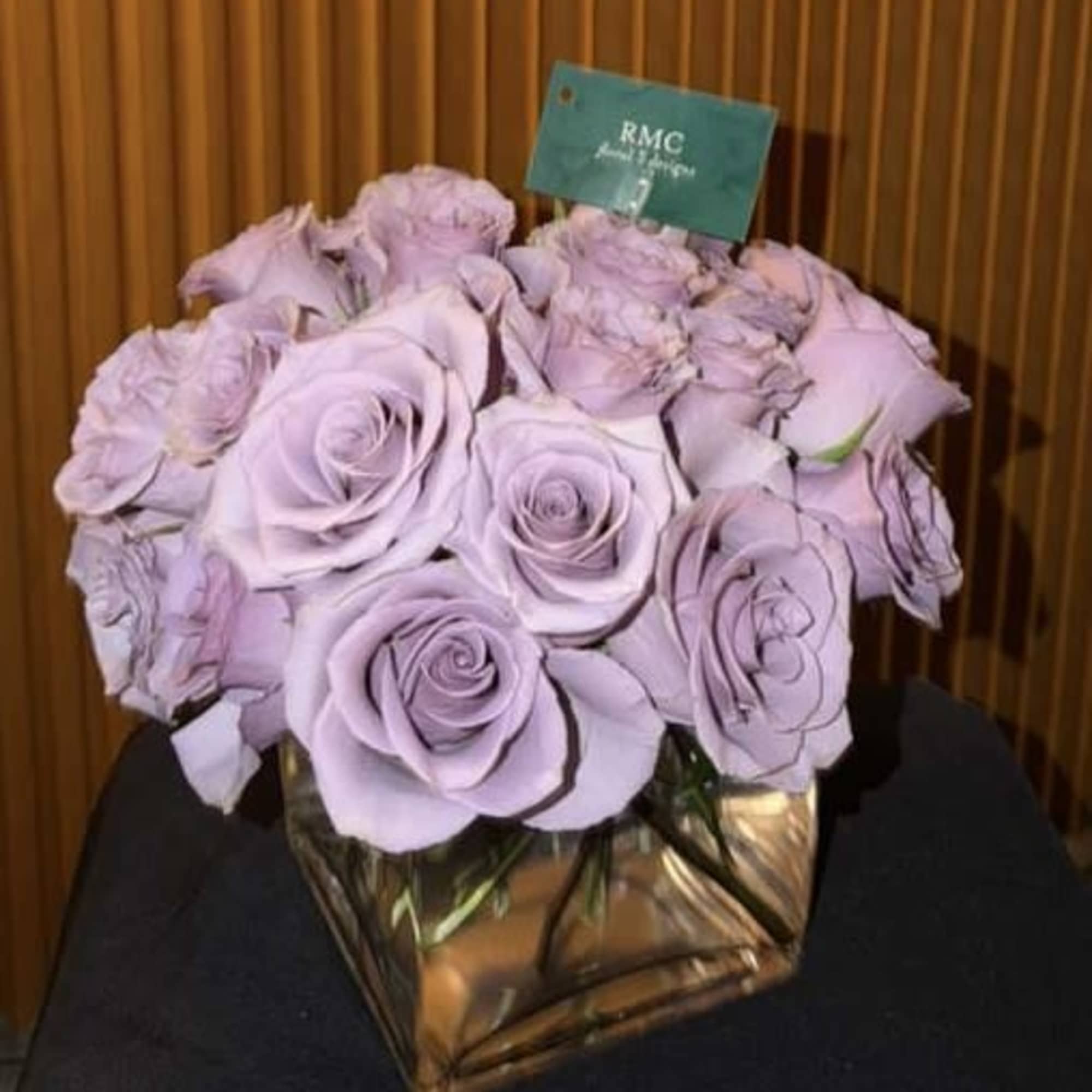 Lavender rose bouquet in a square glass vase