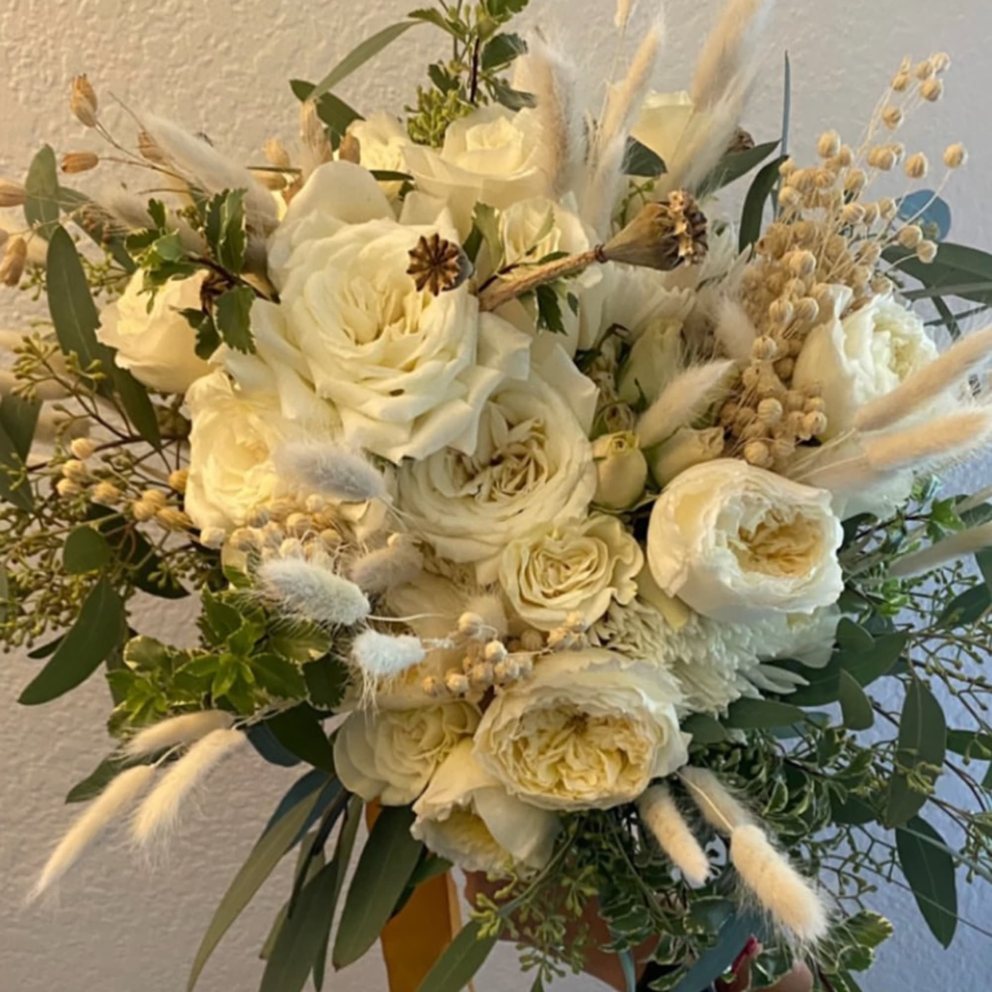 White rose bouquet with airy dried accents and greenery