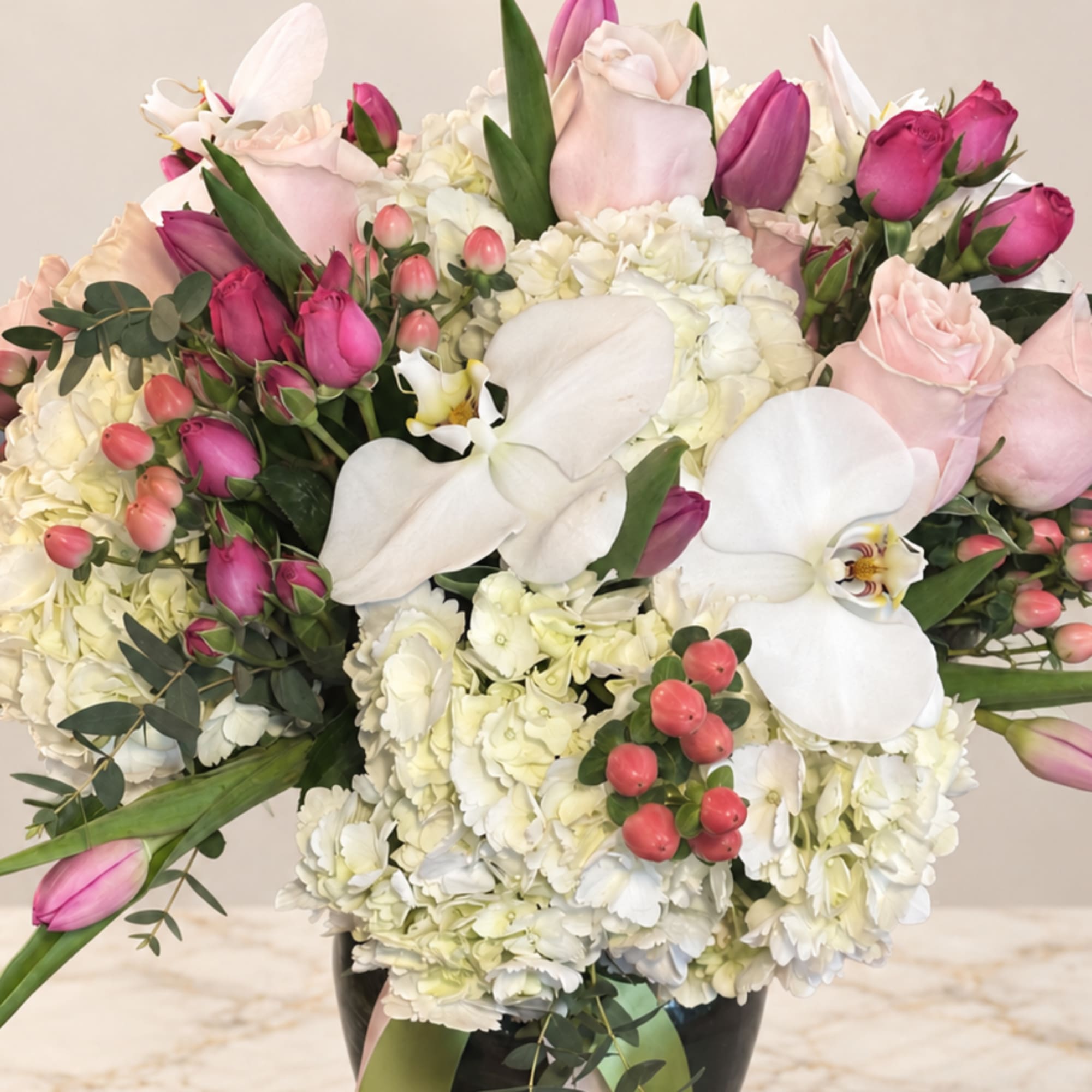 Pink and white floral arrangement in a black vase, photo 2 of 2