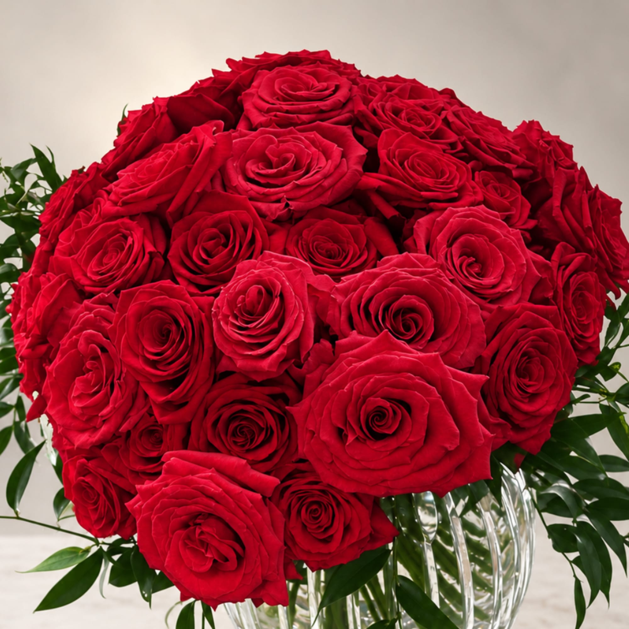 Large bouquet of red roses in a clear glass vase