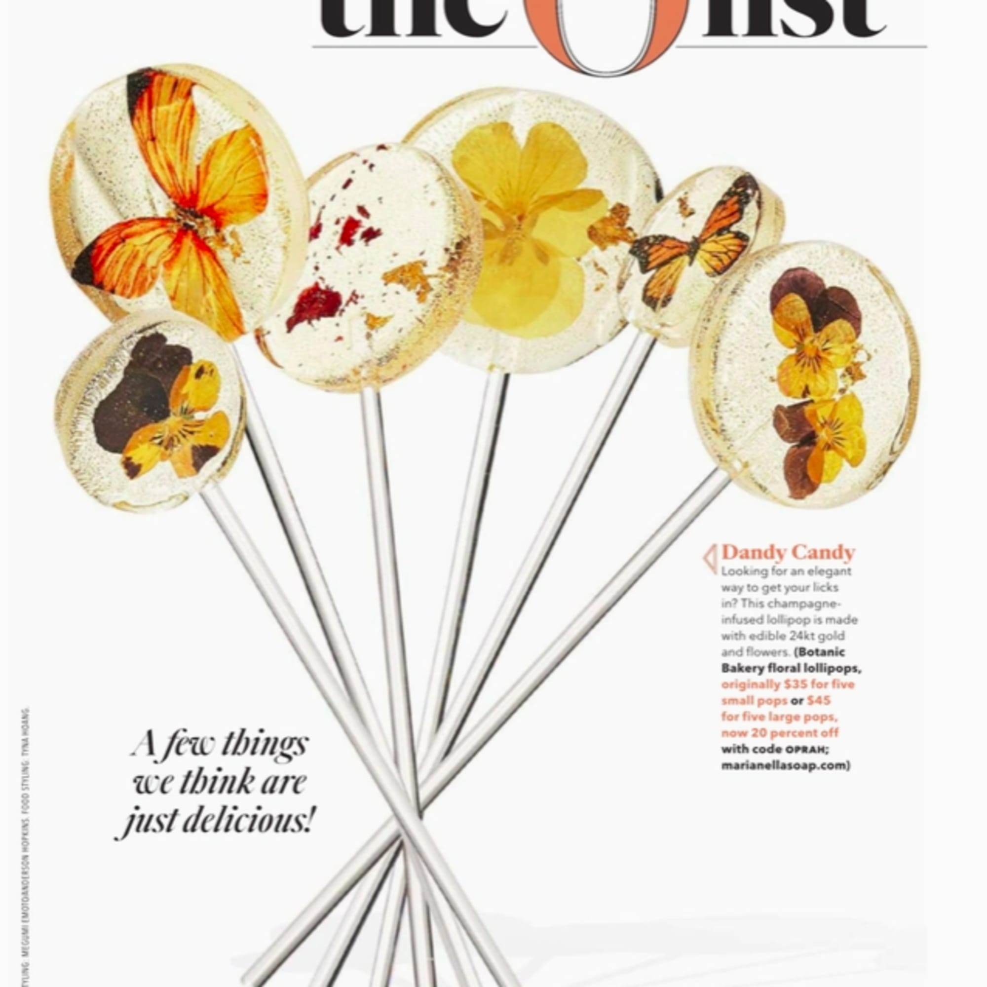 Clear lollipops with pressed yellow flowers and butterflies on long silver sticks