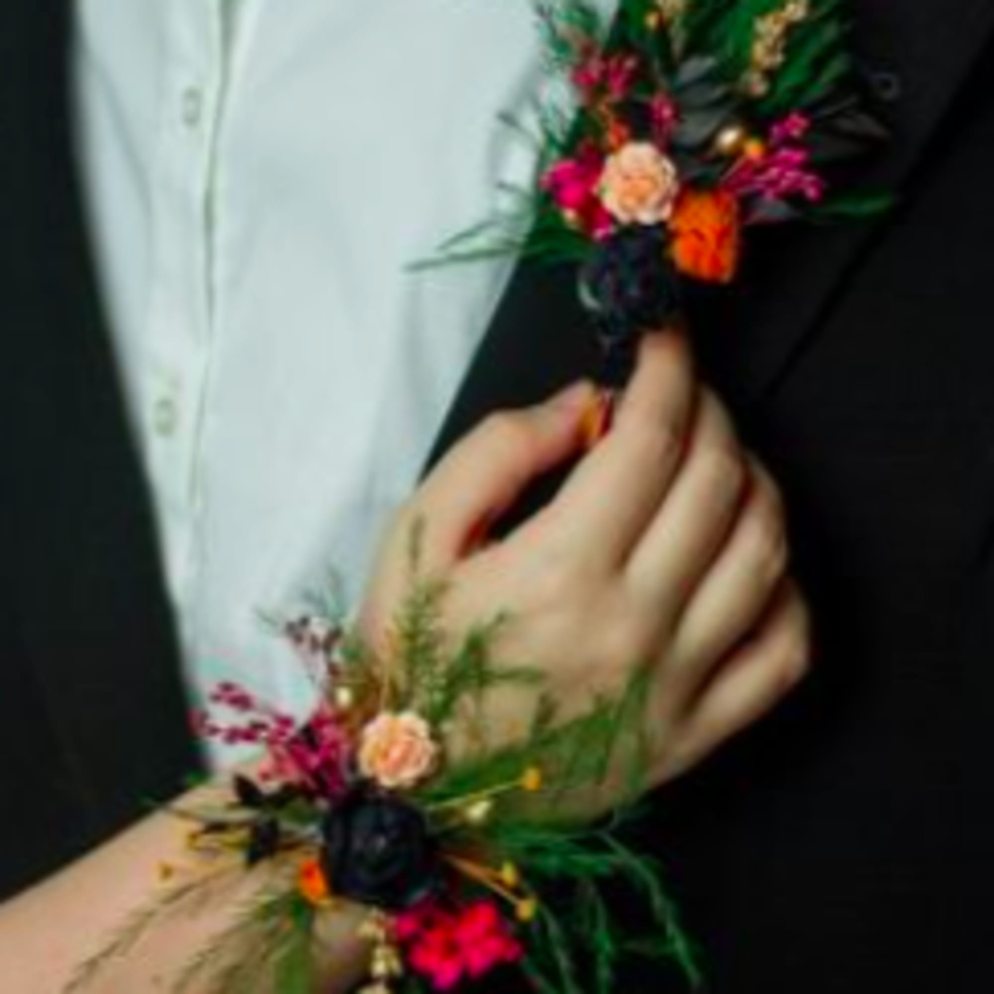 Boutonniere and wrist corsage with pink and orange flowers