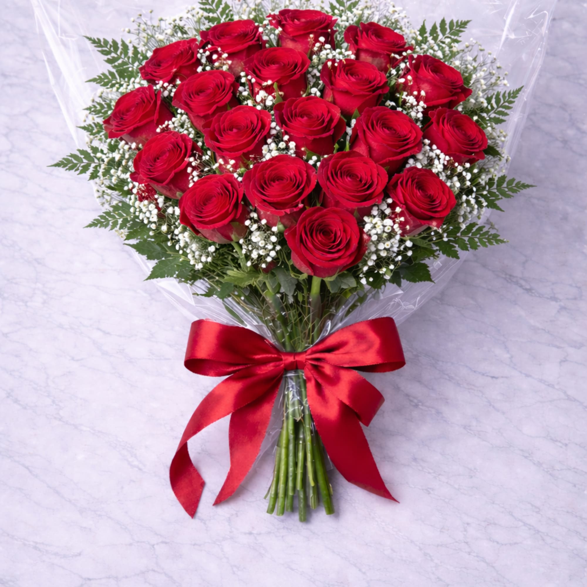 Bouquet of red roses with baby's breath and a red ribbon