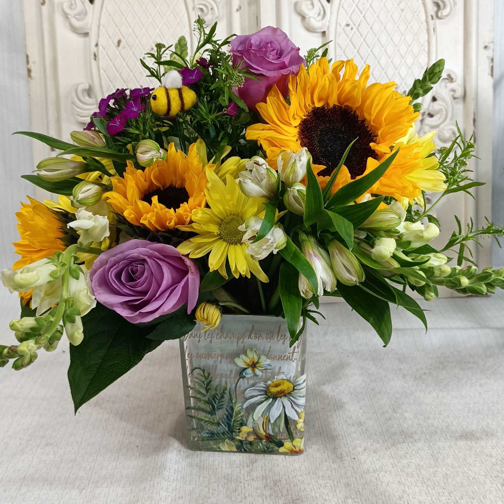 Golden sunflowers and lavender roses create an instant smile in this Bee, photo 2 of 2