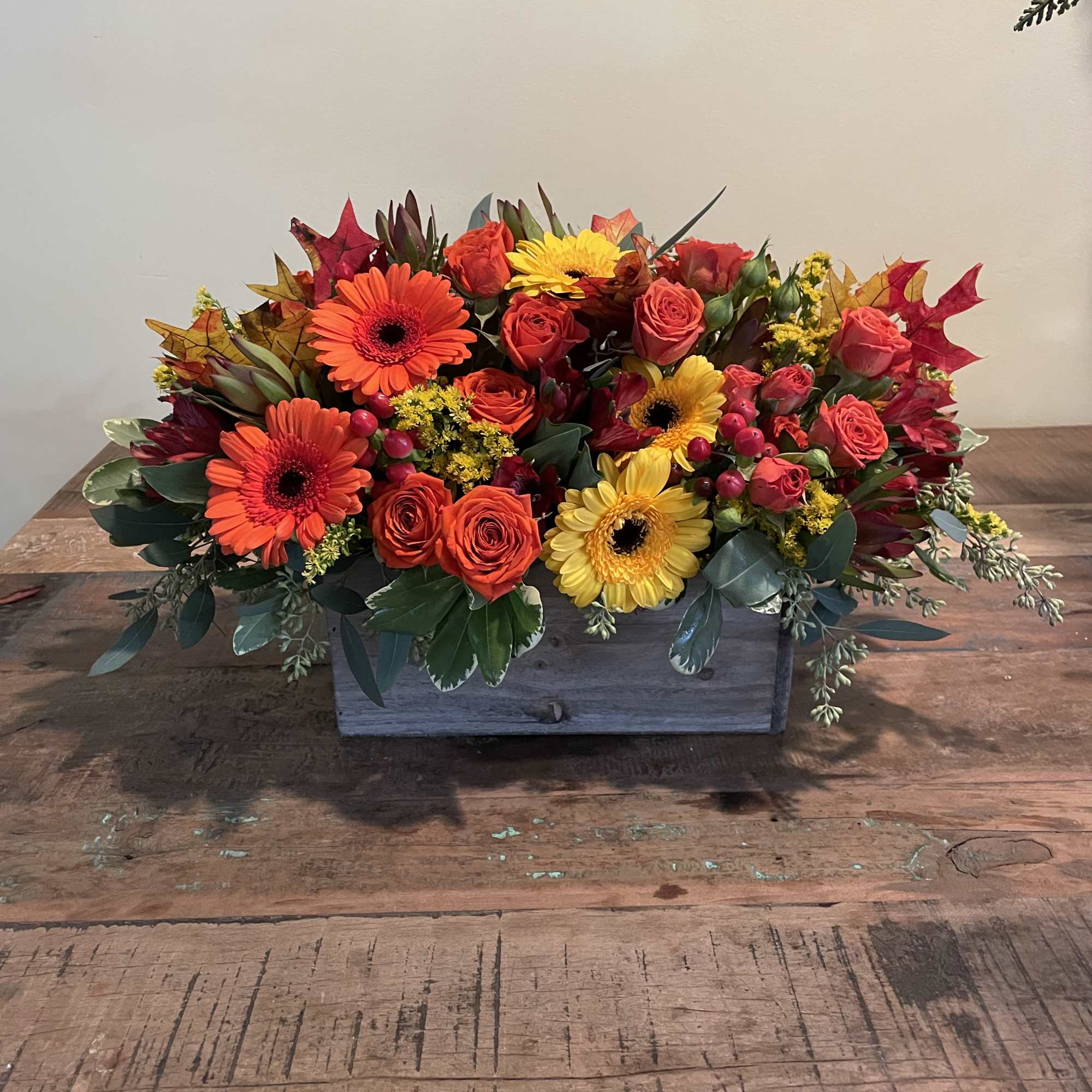 This long centerpiece in a wooden box will brighten up and thanksgiving