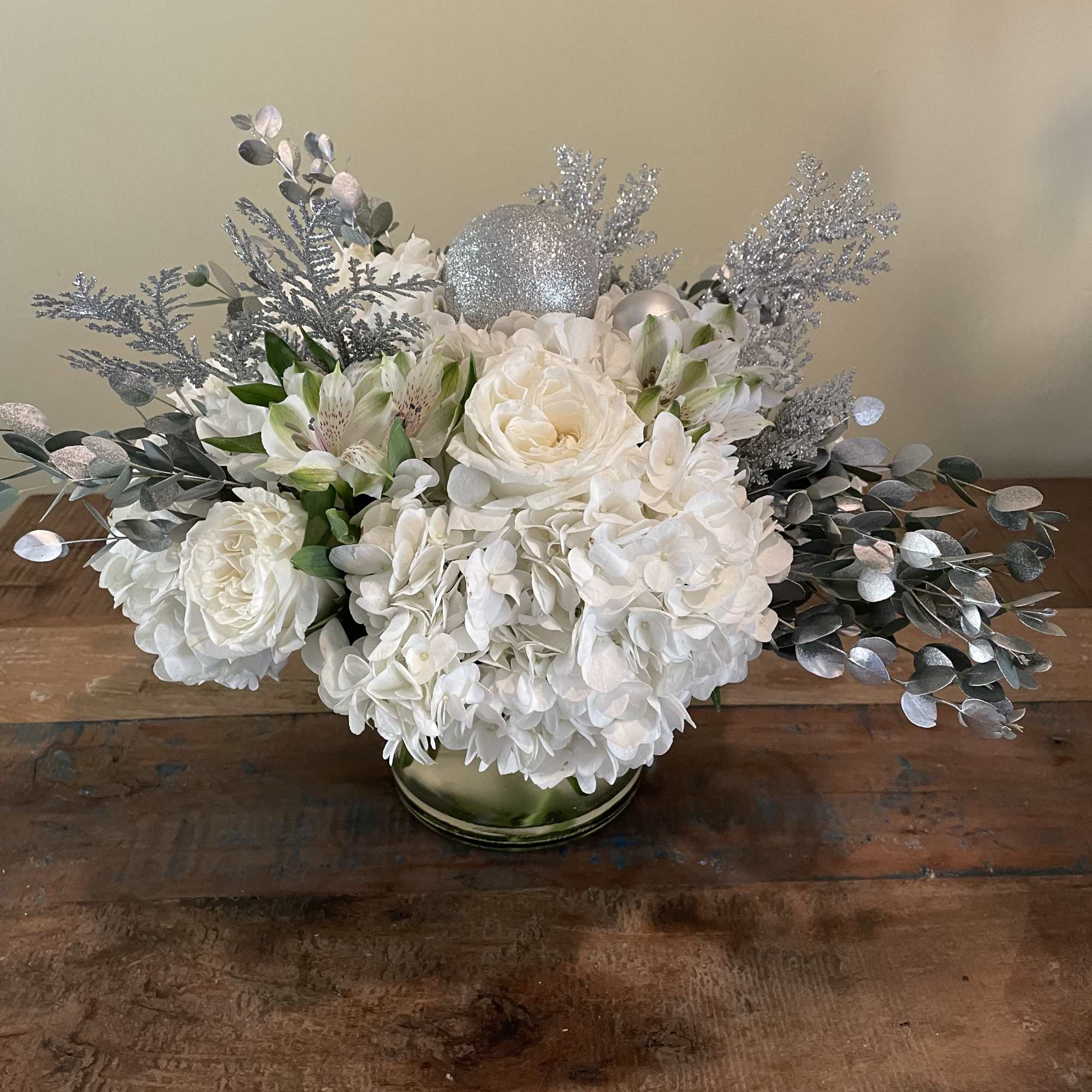 White hydrangea, white roses and silver adornments will add sparkle to anyone&rsquo;s
