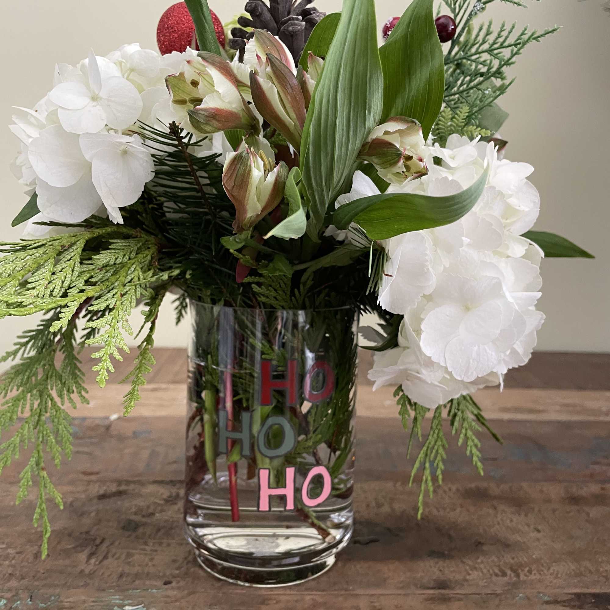 White and green hydrangea, alstromeria, berries and cones