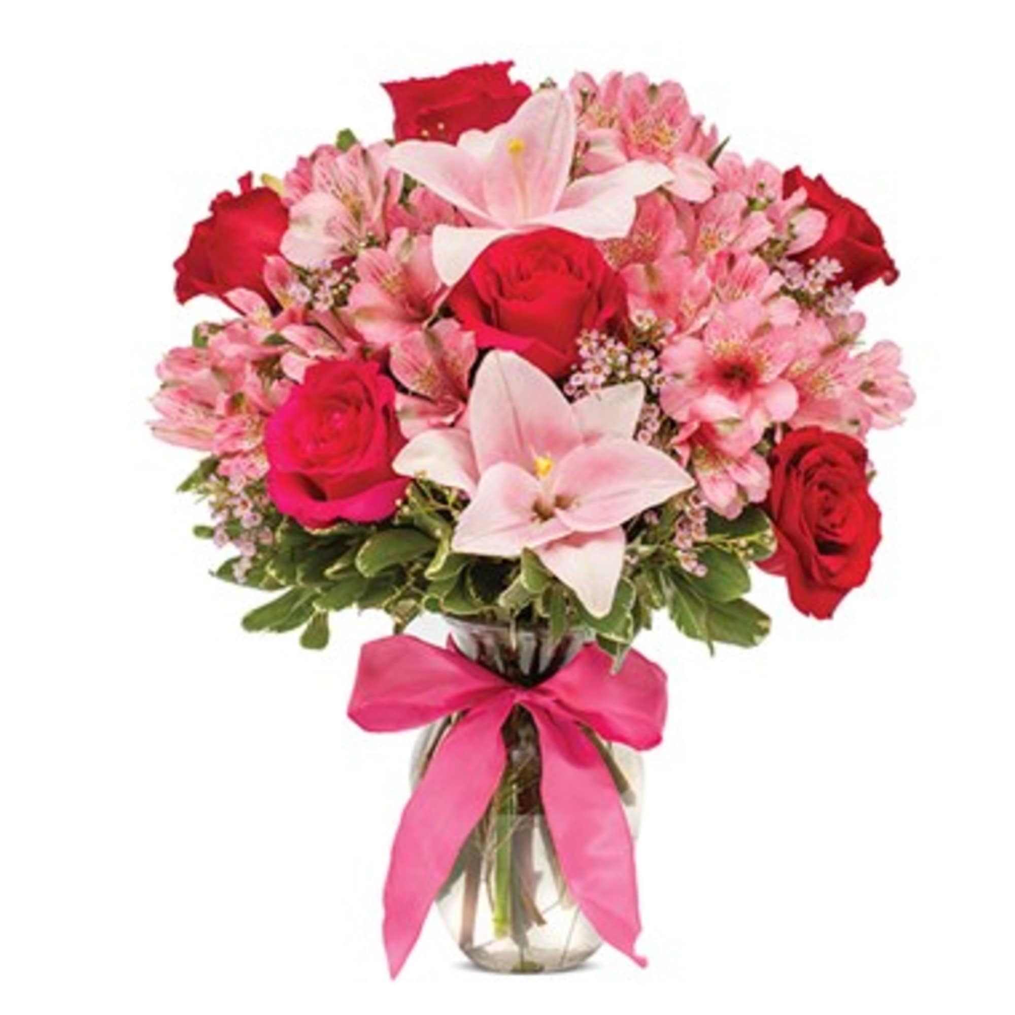 Bouquet of pink and red flowers in a glass vase with a pink ribbon
