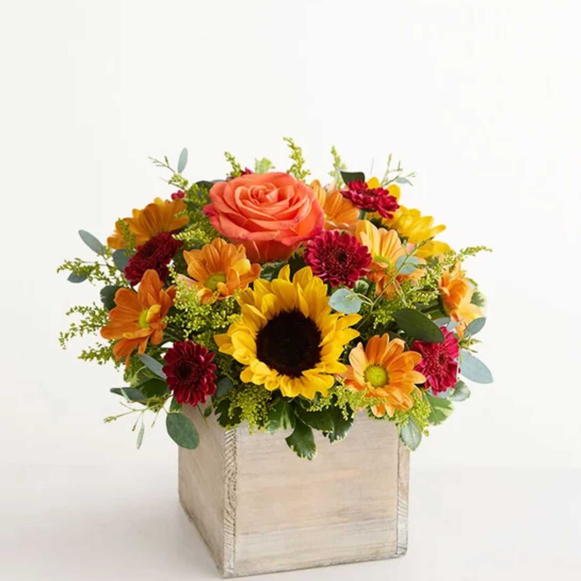 Mixed bouquet with a sunflower, rose, and daisies in a square wooden box