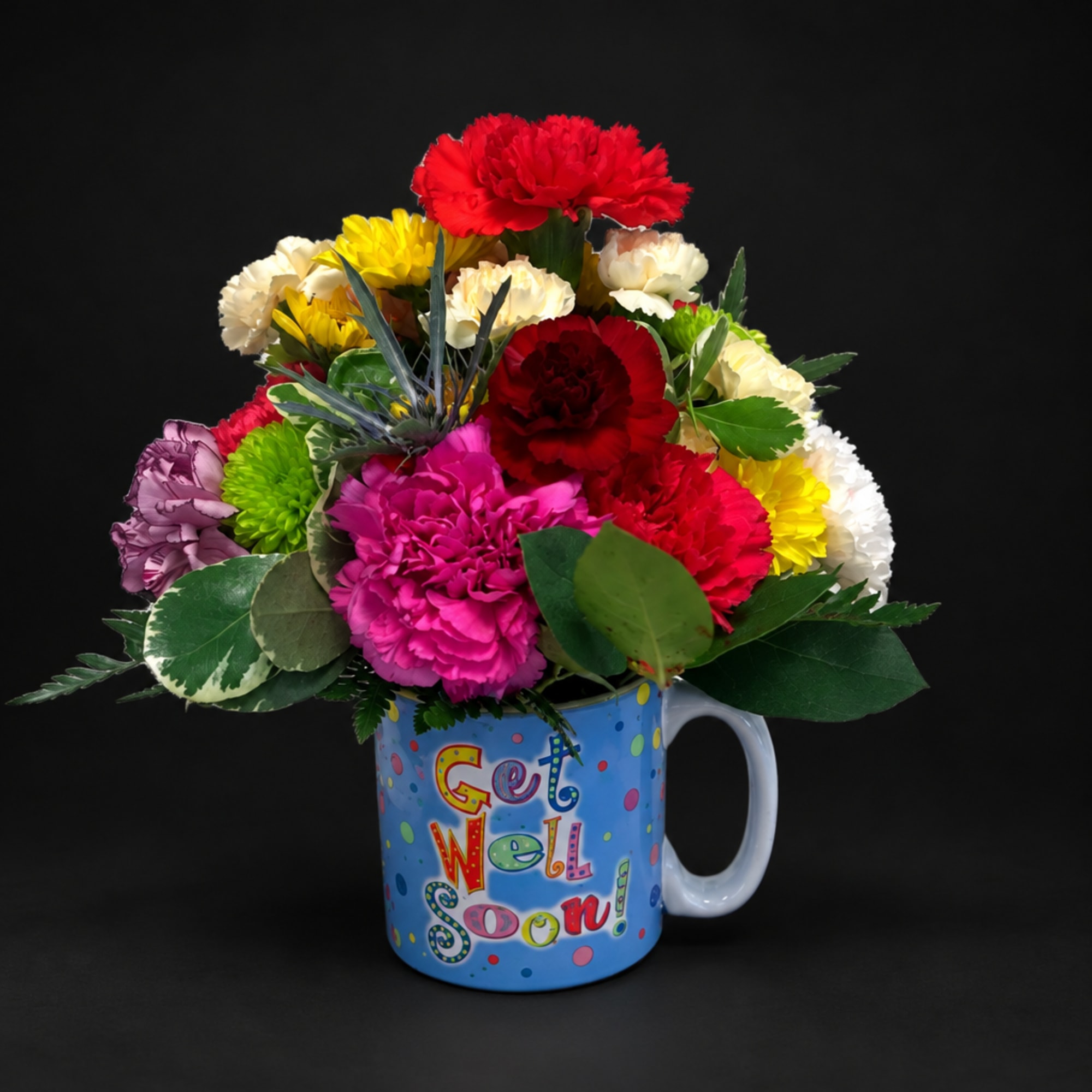 Colorful carnation bouquet in a blue mug with a "Get Well Soon" message