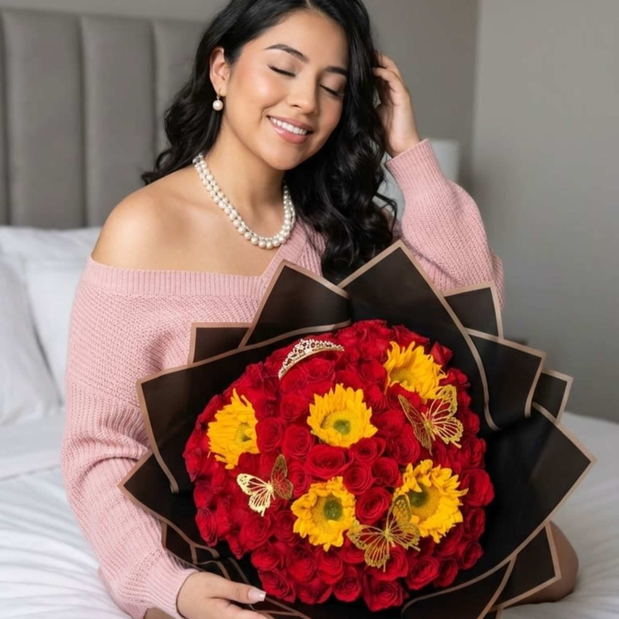 Woman holding a bouquet of red roses and yellow daisies wrapped in black paper