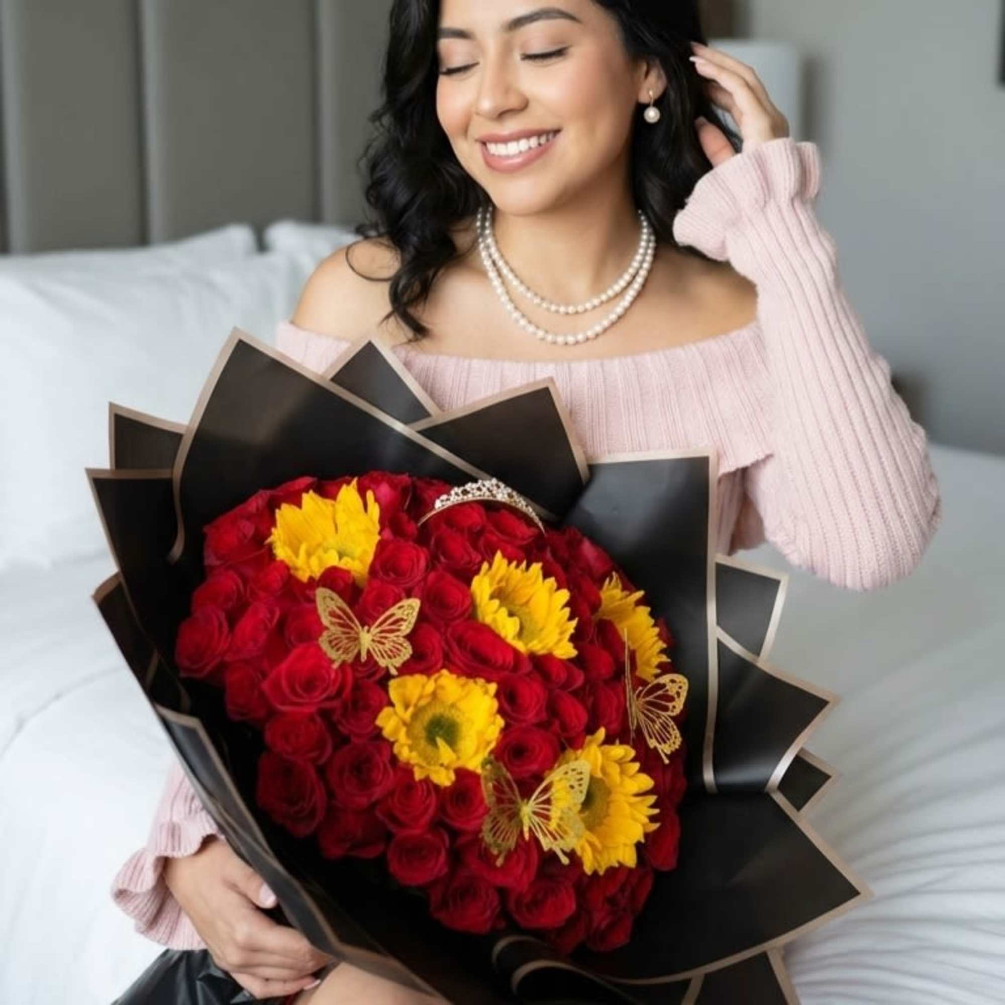 Woman holding a bouquet of red roses and yellow flowers