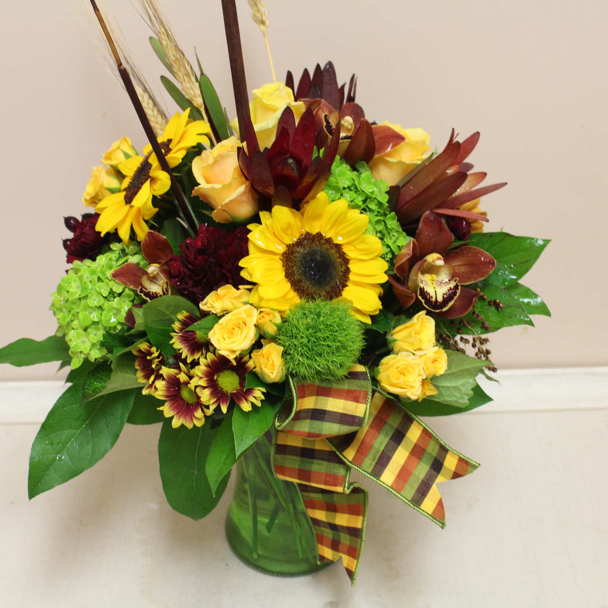 Autumn vase filled with mixed autumn flowers, assorted poms, spray roses, mini