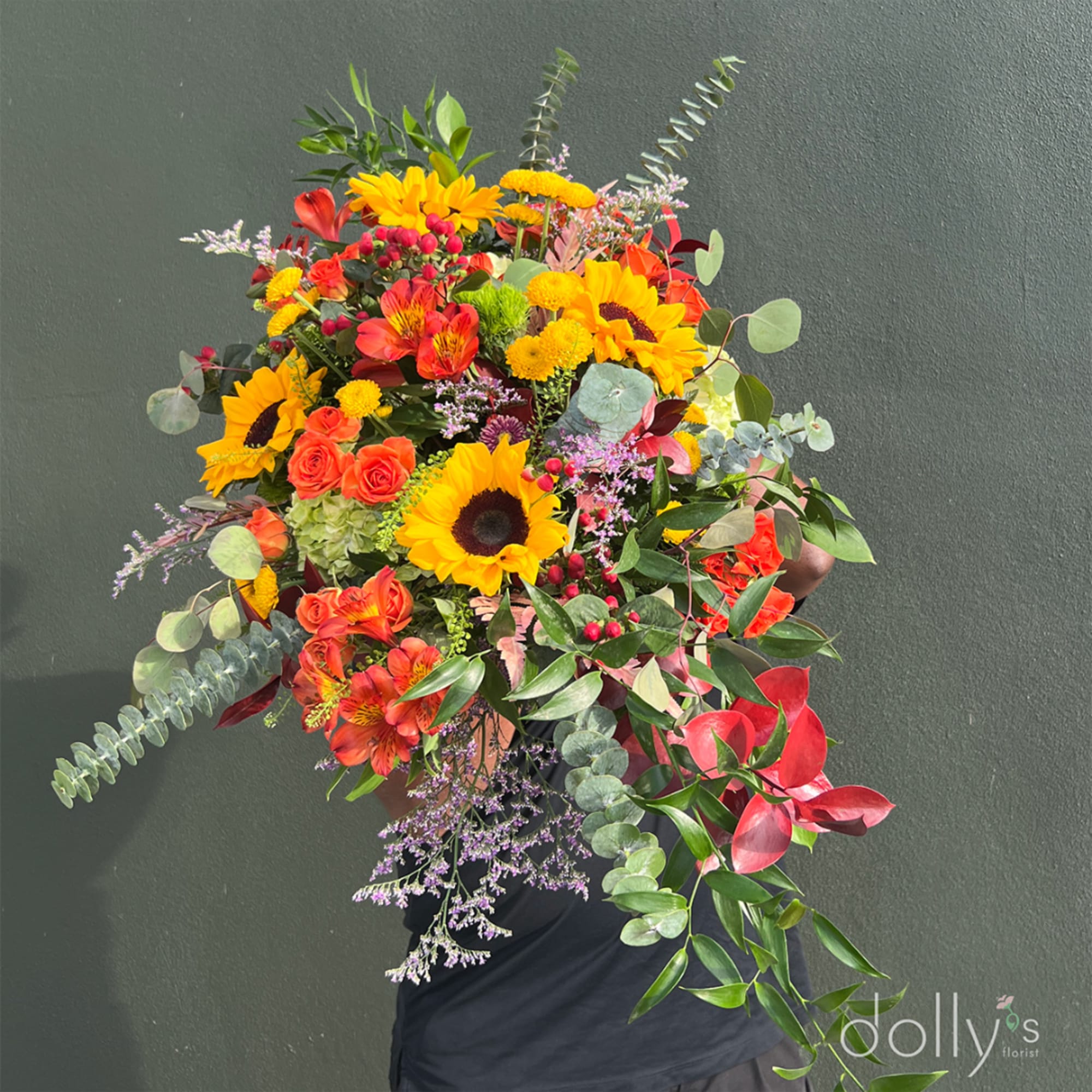 Large bouquet of sunflowers, orange roses, and red alstroemeria