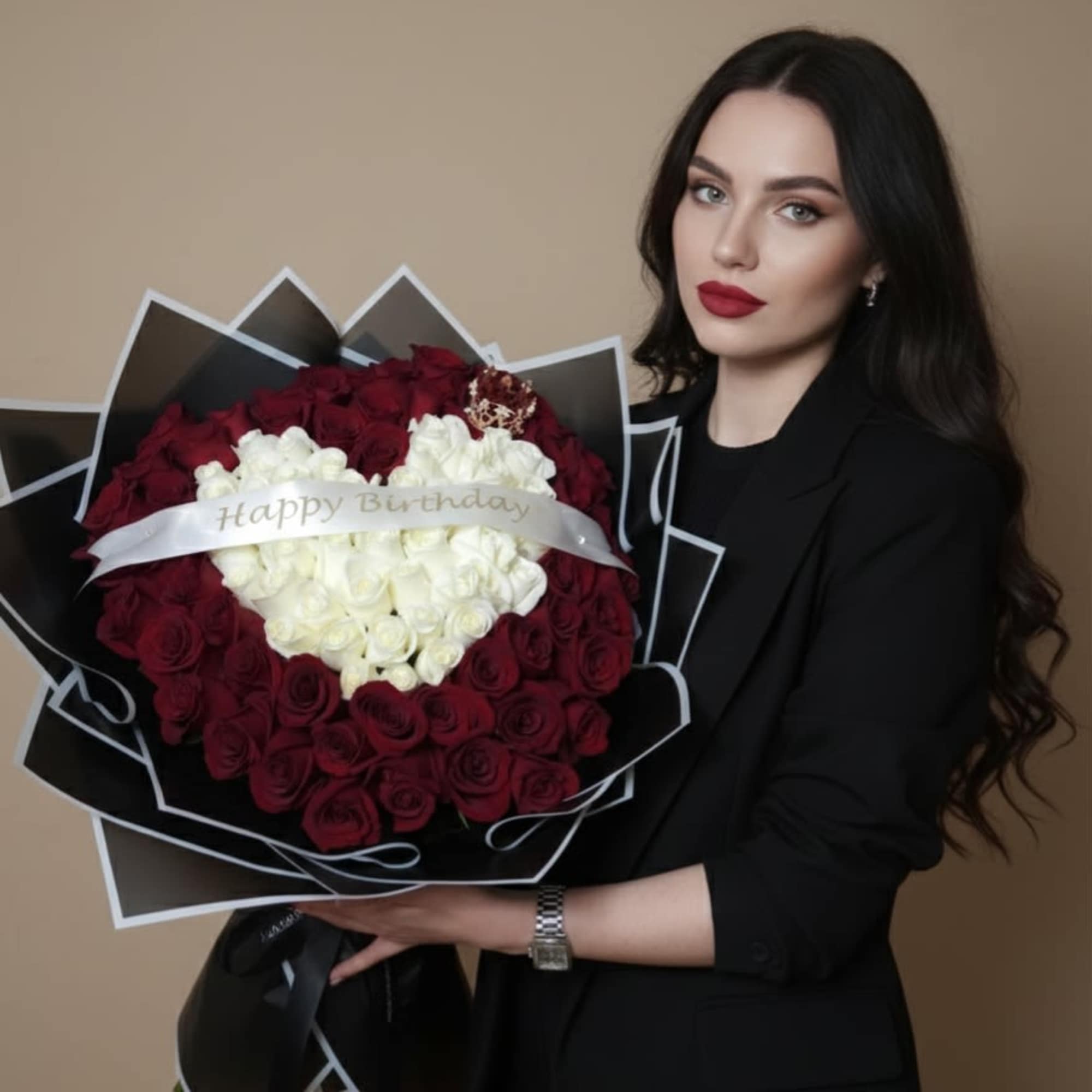 Woman holding a large bouquet of red and white roses with a birthday ribbon