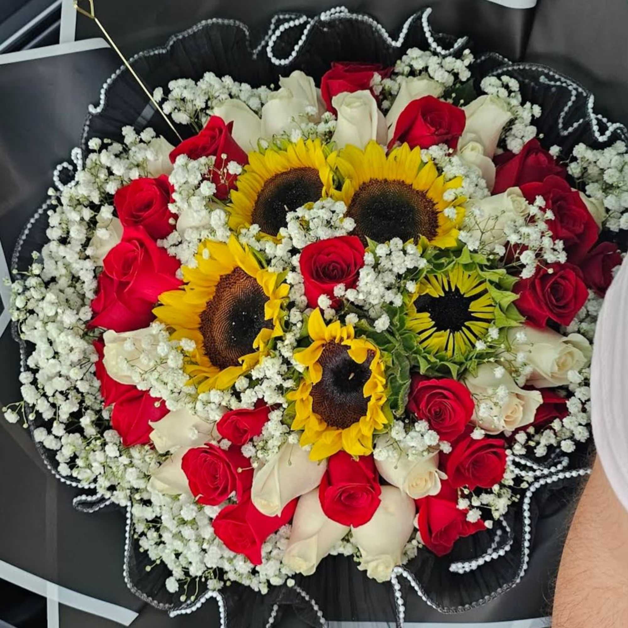 Bouquet of red and white roses with sunflowers and baby's breath