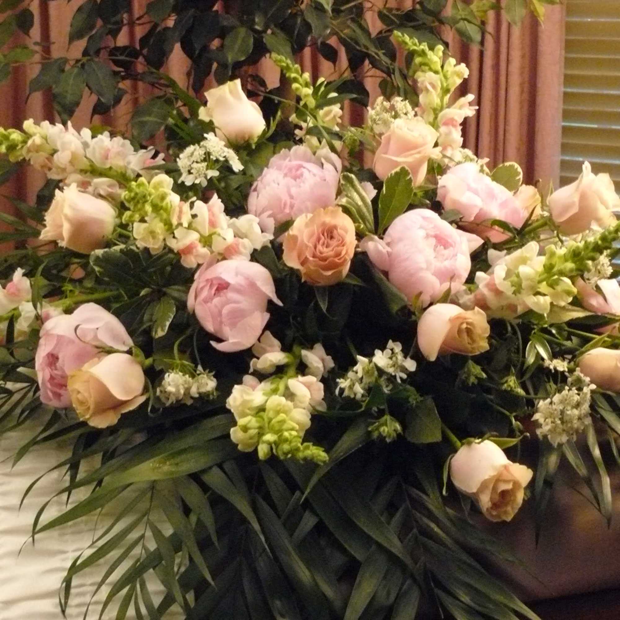 Large pastel floral arrangement with roses and peonies
