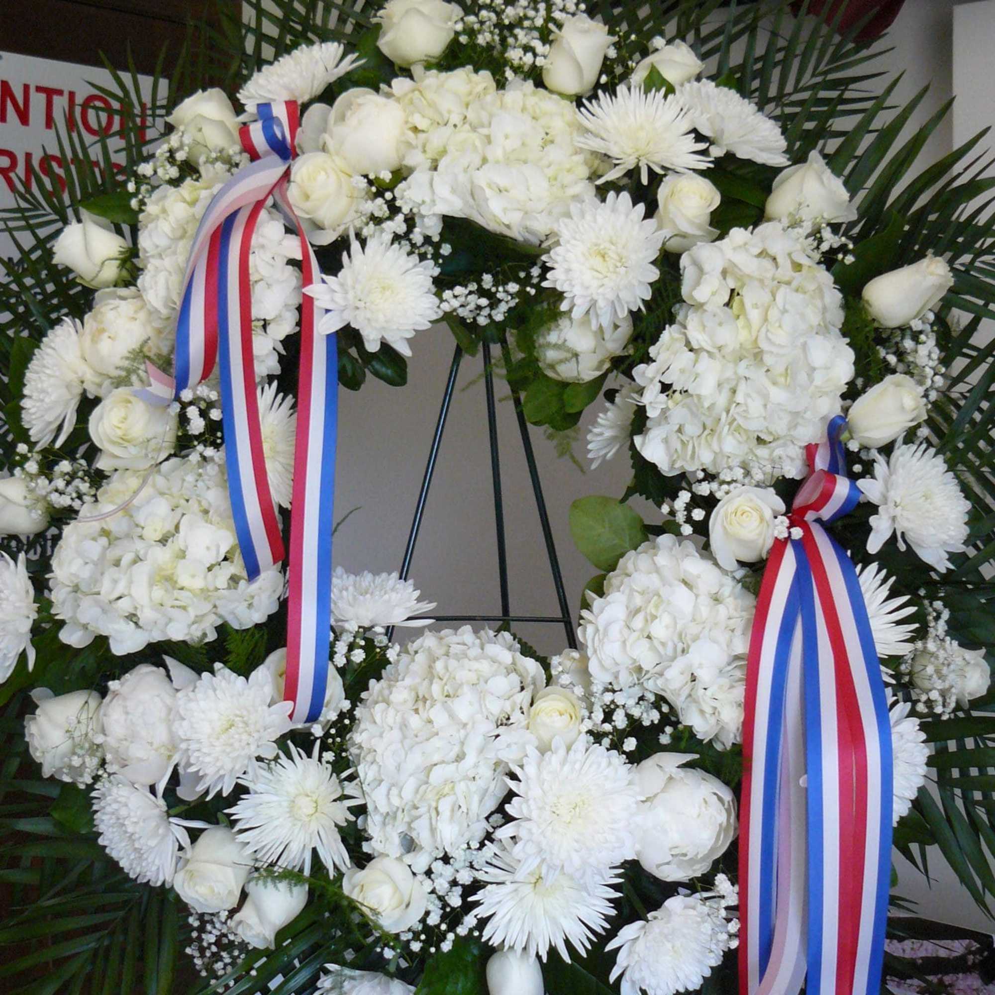 Peonies(Sesasonal), Roses, Cremons, Mums, Hydrangea, Babies Breath, Ferns Fancy Greens, Ribbon.

Call Store