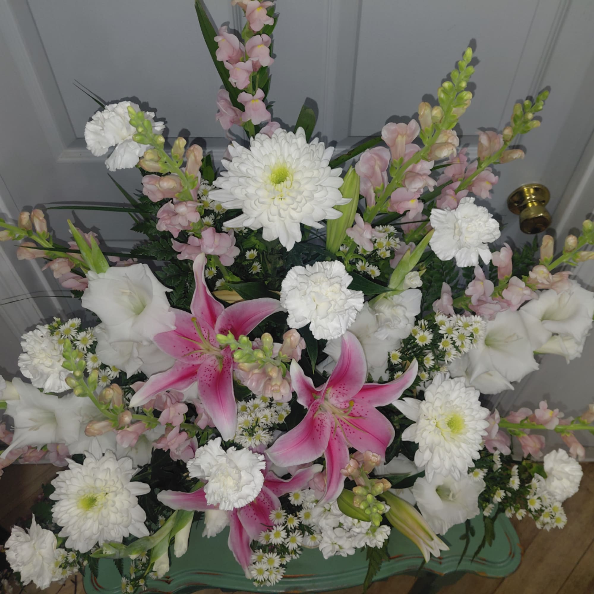 Pink lilies and white chrysanthemums arranged in a vase