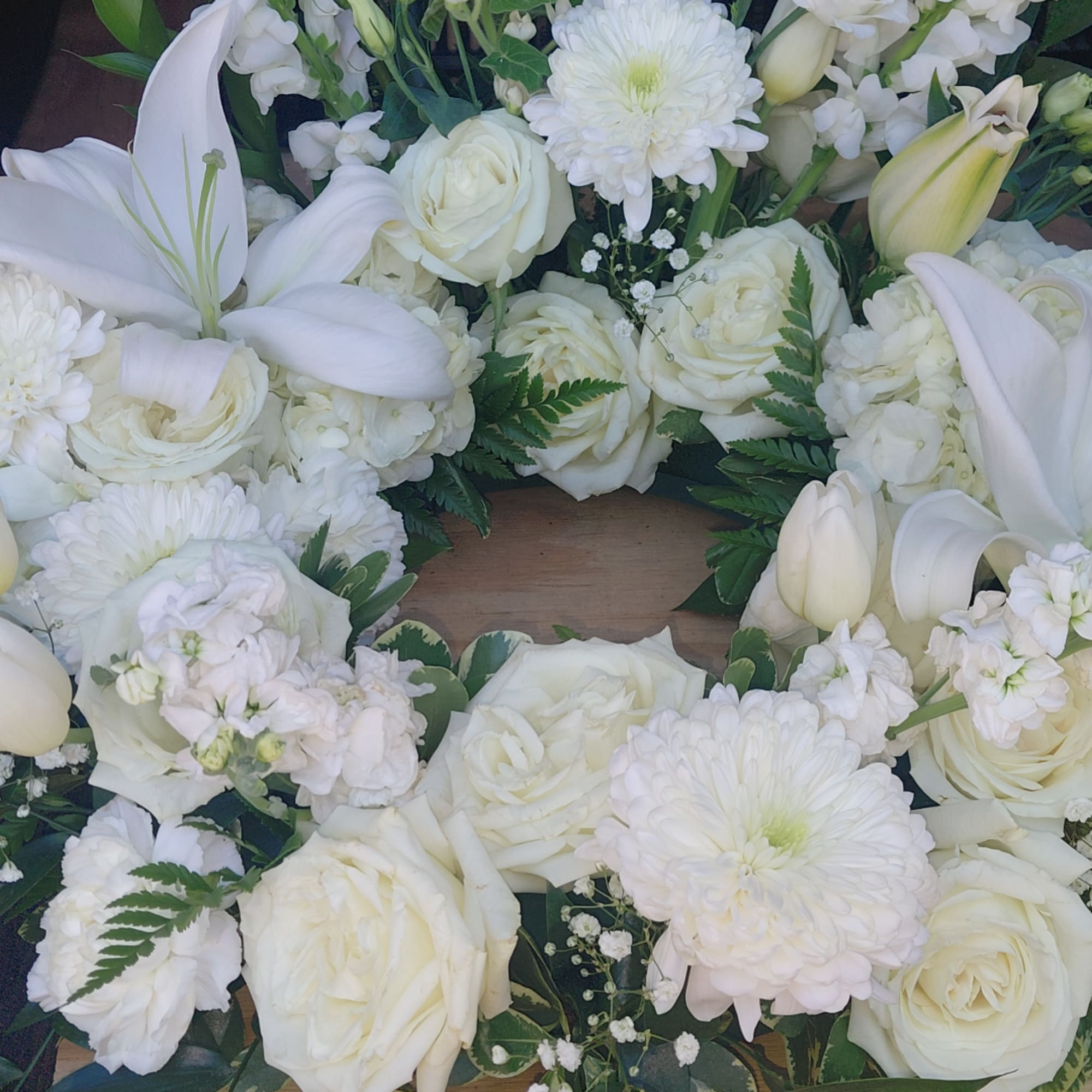 White floral wreath with roses, lilies, and chrysanthemums, photo 2 of 2