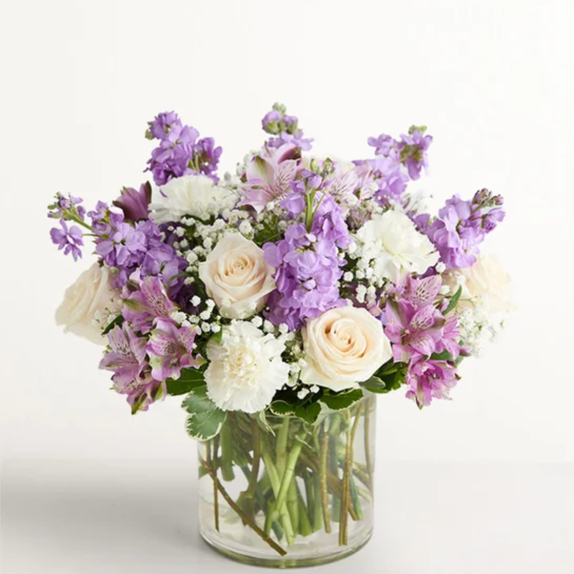 Lavender and white mixed bouquet in a clear glass vase