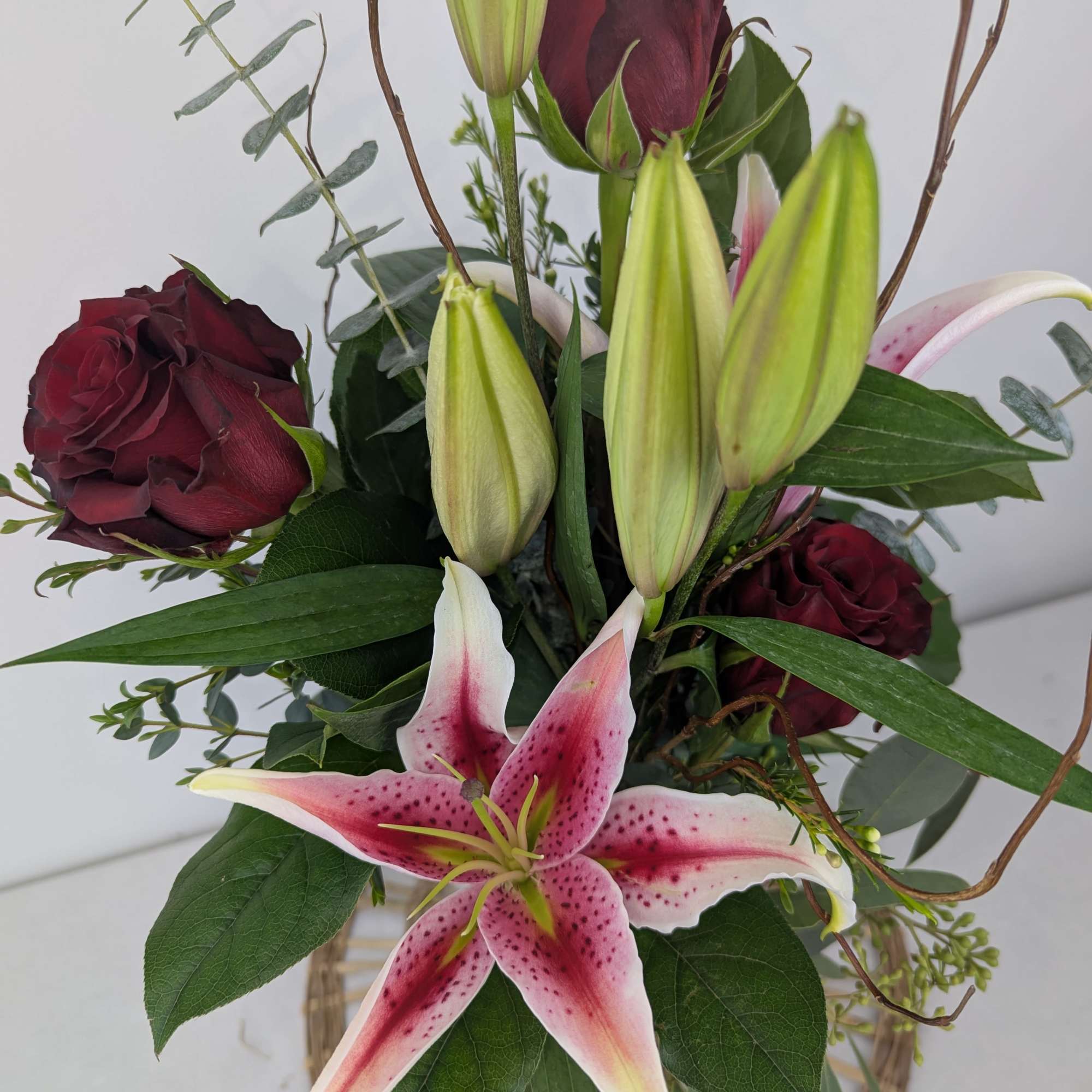 Bouquet of burgundy roses and pink stargazer lilies