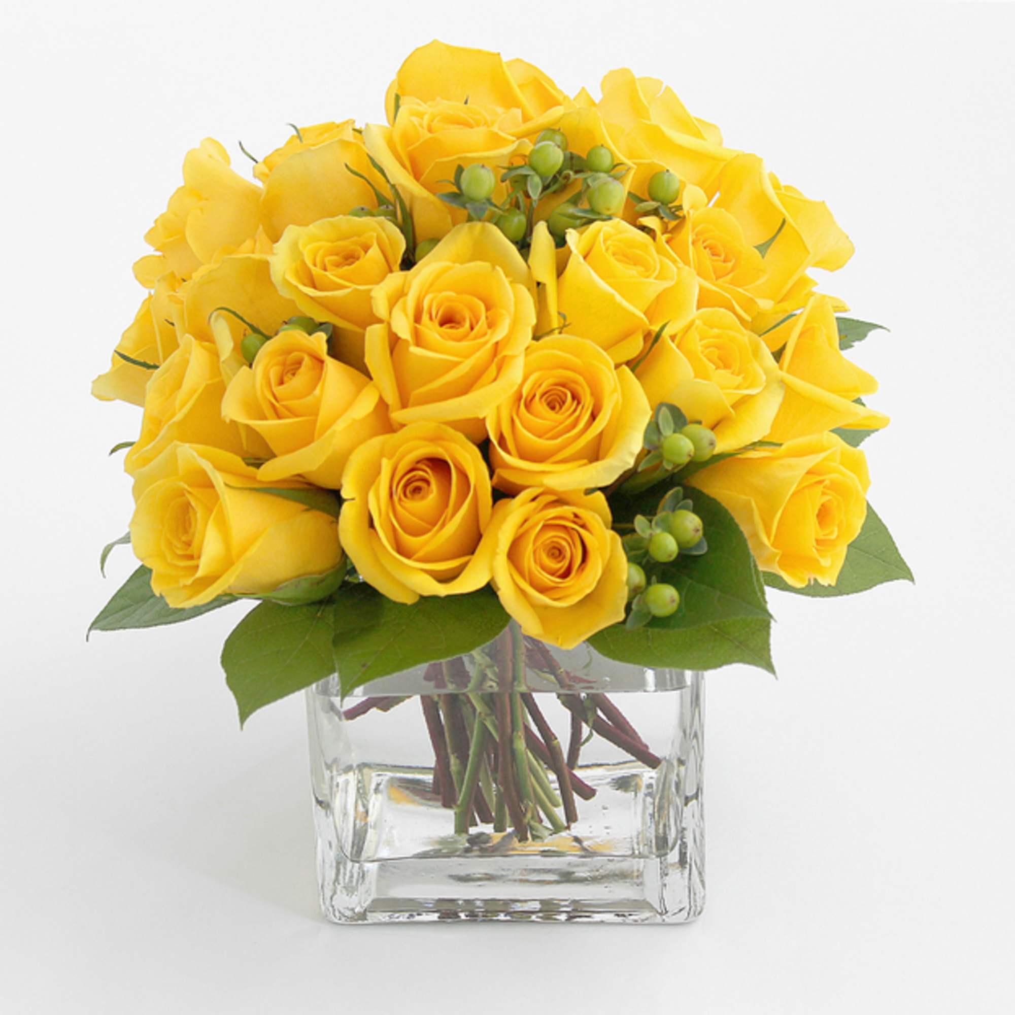 Yellow roses arranged in a clear glass vase
