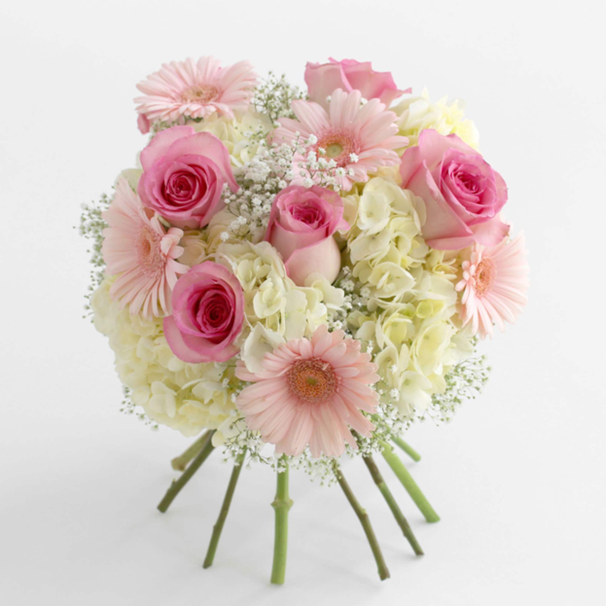 Pink roses and pale gerbera daisies in a round bouquet