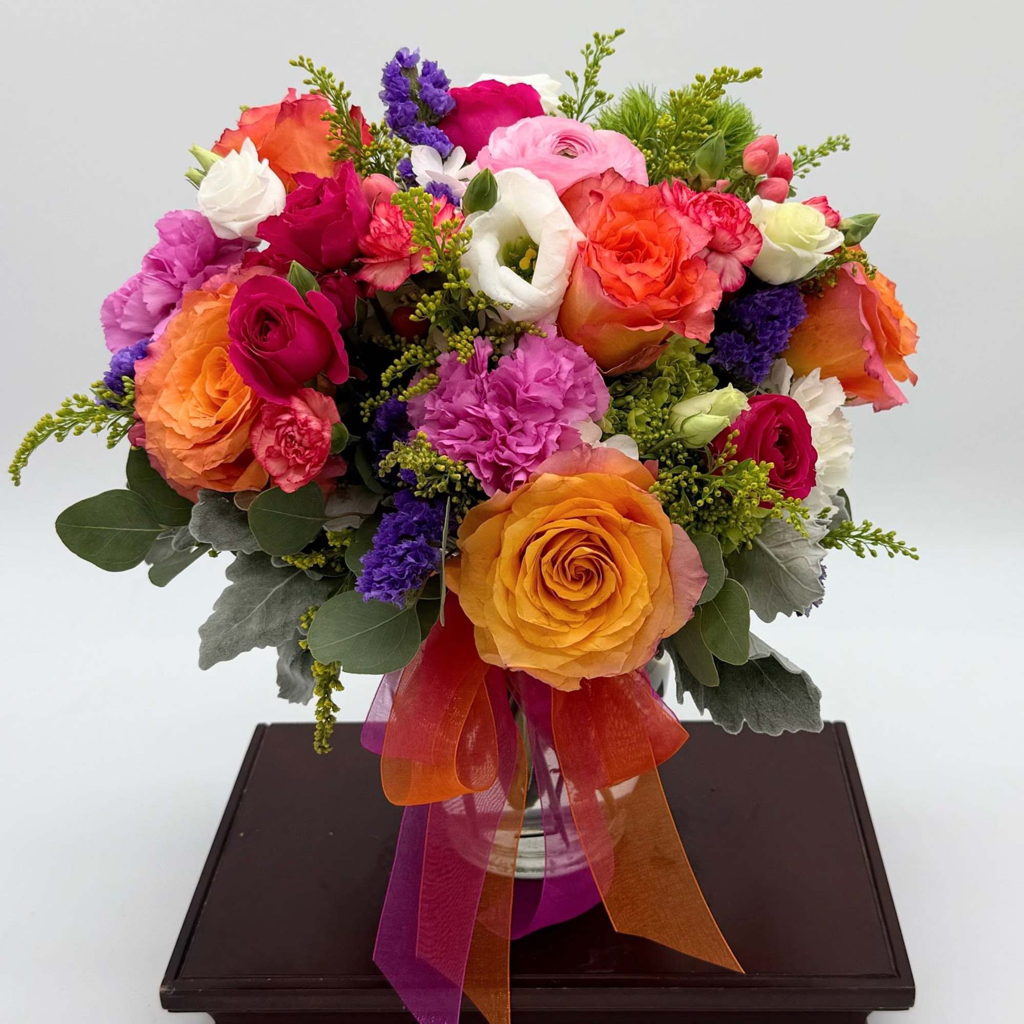 Brighten their day with this warm and  exciting mix featuring roses