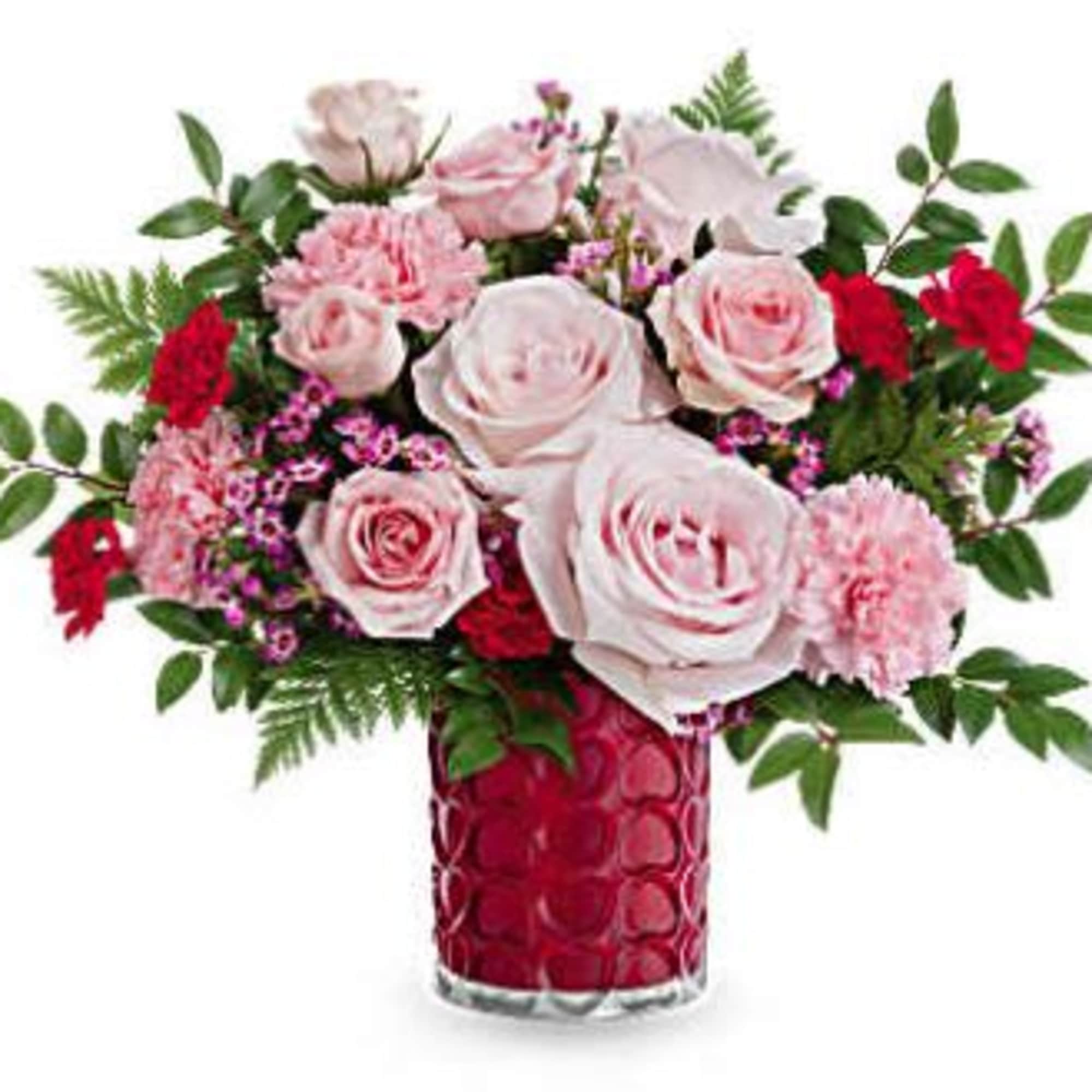 Pink and red rose bouquet in a red glass vase