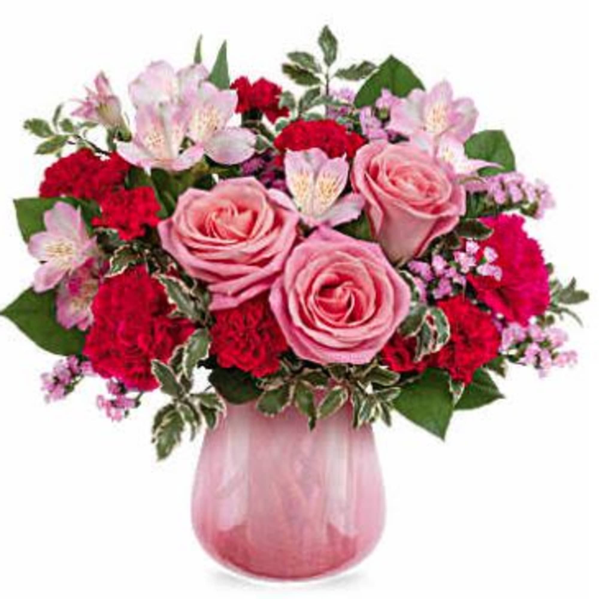 Pink roses and red carnations in a pink glass vase